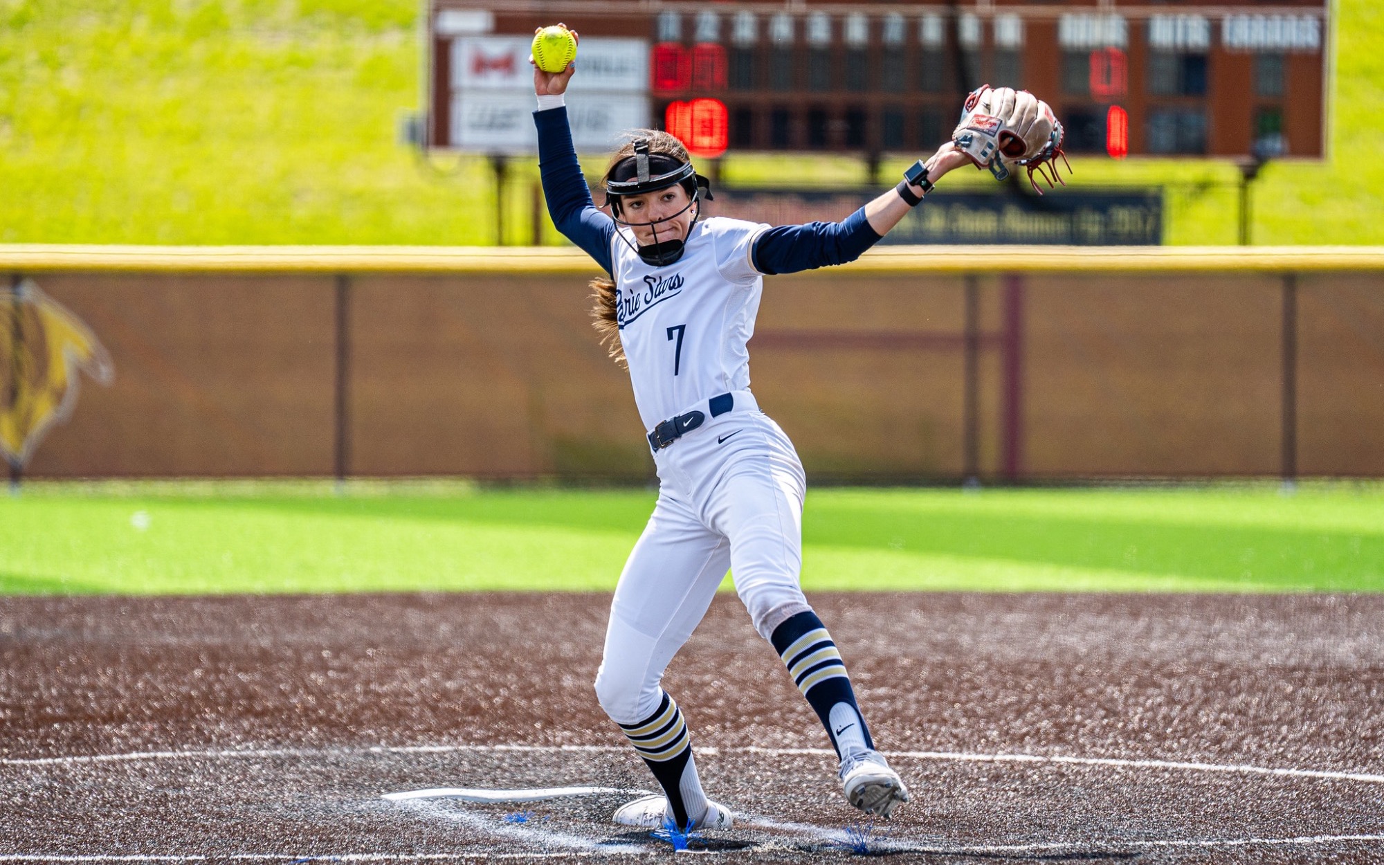 Rosie Bartletti pitching in white uniform in GLVC Tournament