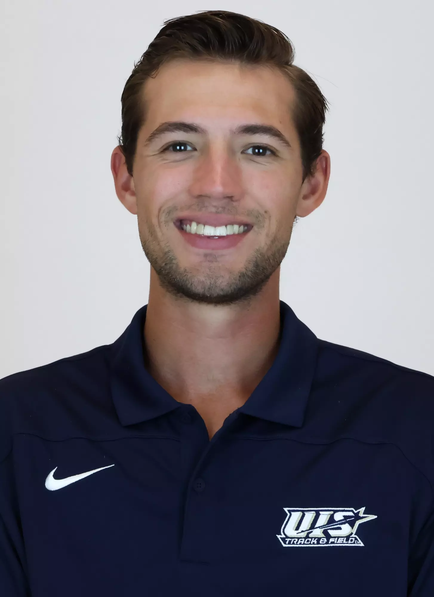 UIS coach Tommy Hufton's headshot in blue UIS polo