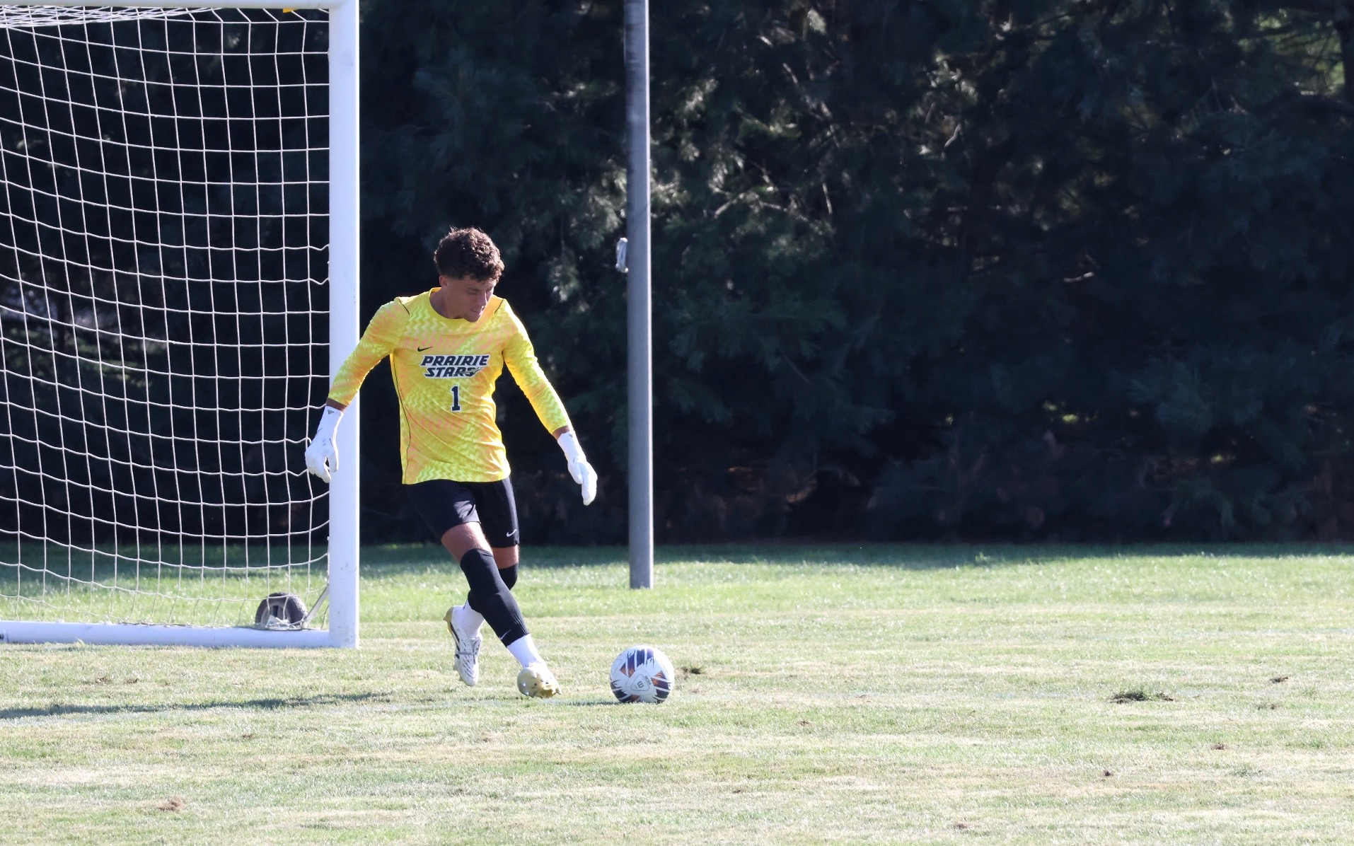 UIS goalkeeper Kevin Kardel kicks ball, yellow jersey