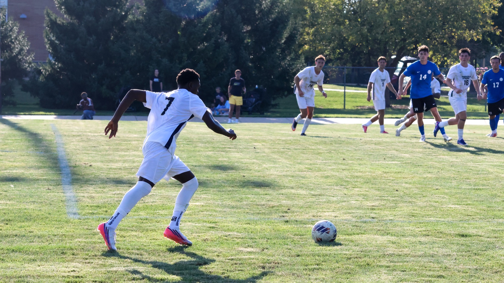 Gentil Selemani bringing ball up field in a UIS soccer game