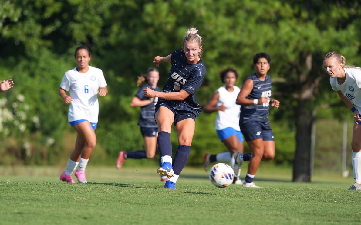 Rachel Riney kicking soccer ball during a game