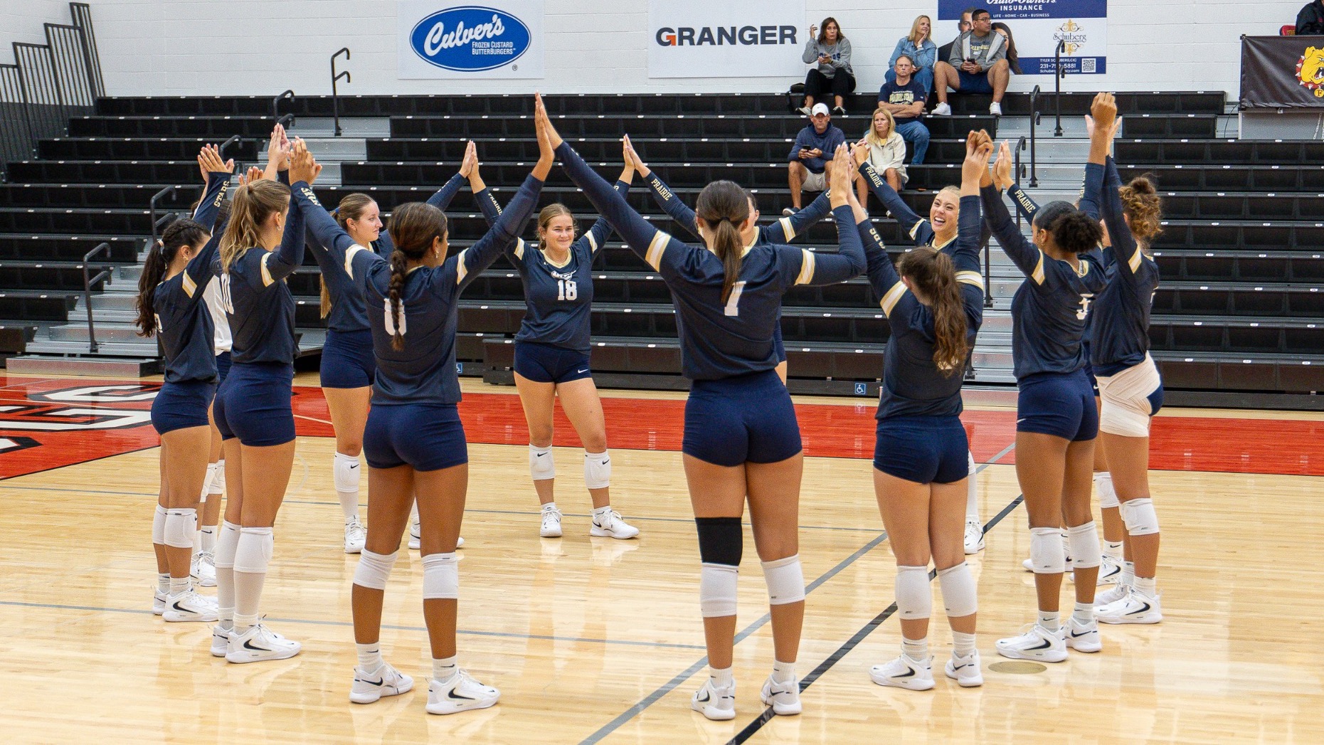 UIS Volleyball team on court together before a match