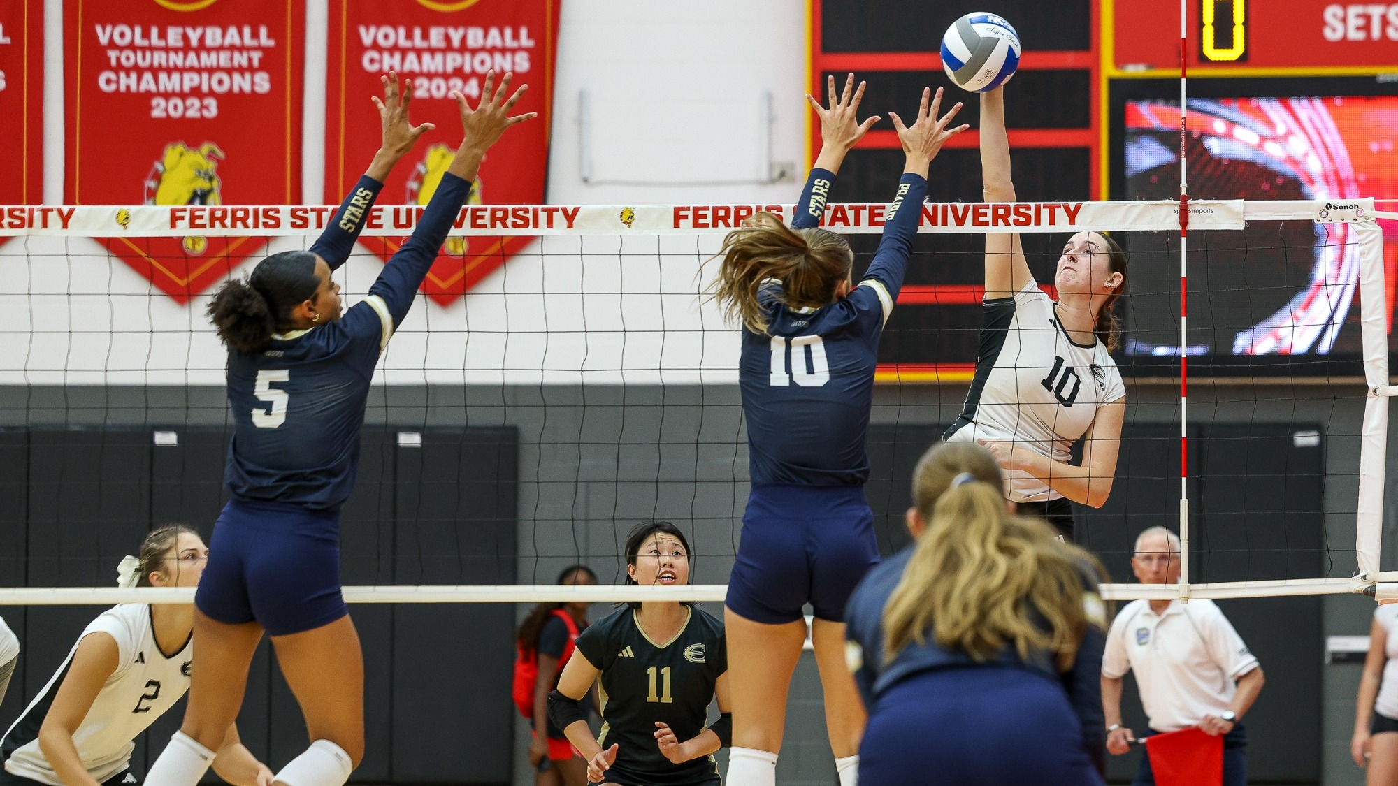 UIS Volleyball players go up for a block