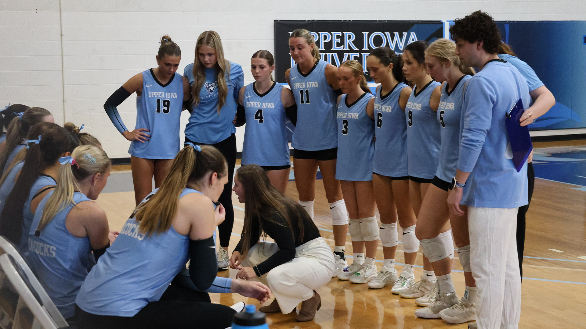 Team huddling vs Rockhurst 2026
