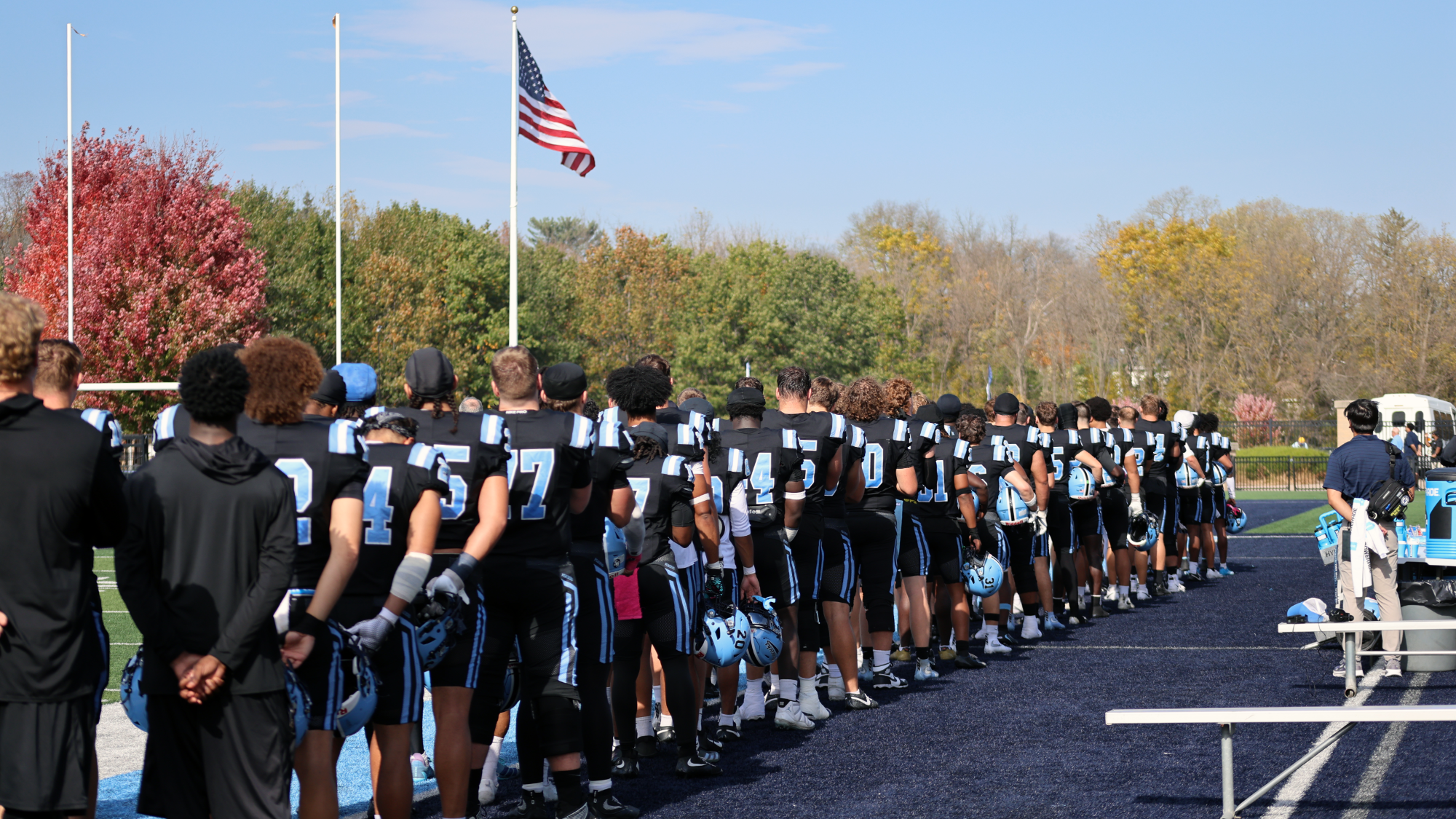 Upper Iowa Football team photo standing for the National Anthem vs. William Jewell 10/24/26