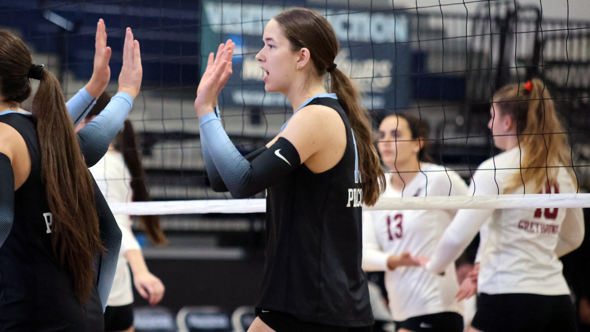 Faith Fisher high fiving vs. UIndy 2026