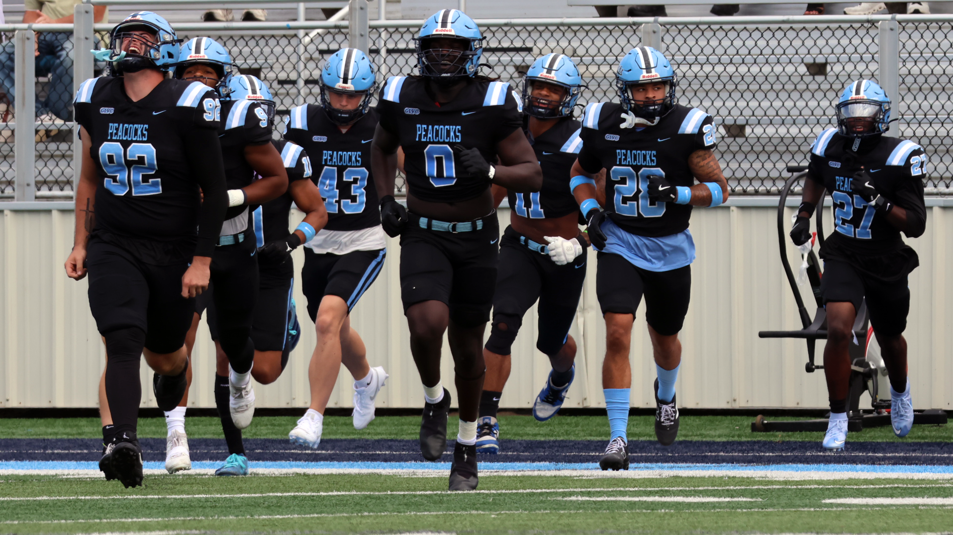 Peacock football running out of tunnel team photo vs. Jamestown 2026