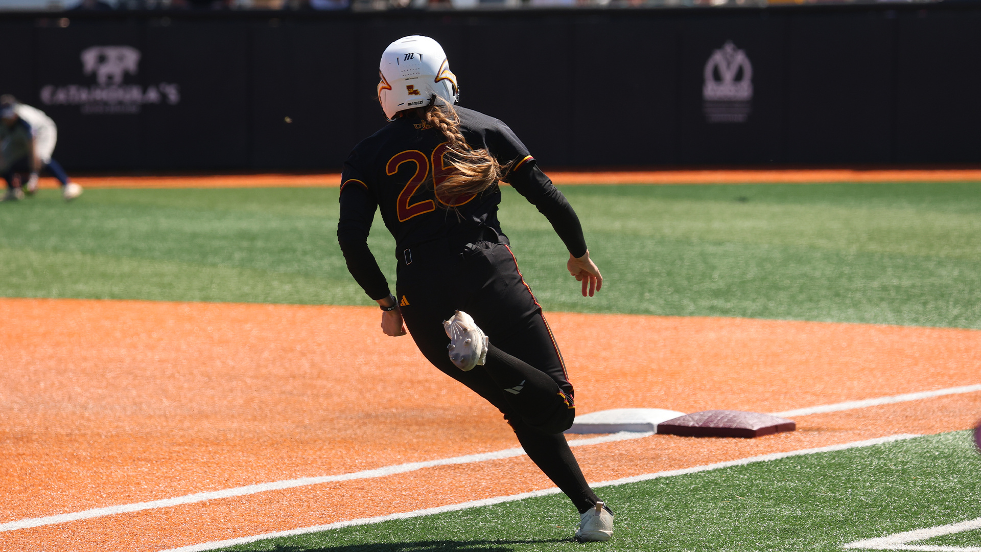 Hollie Thomas running the base path in a softball game