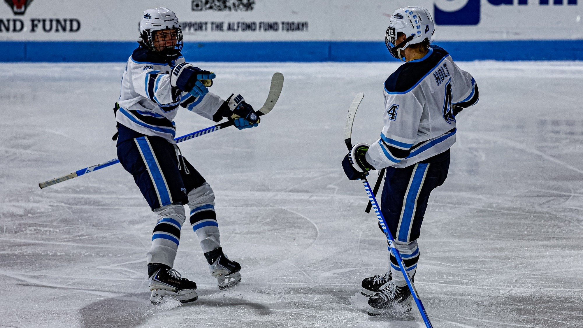 Maine men's hockey celebrates a goal.