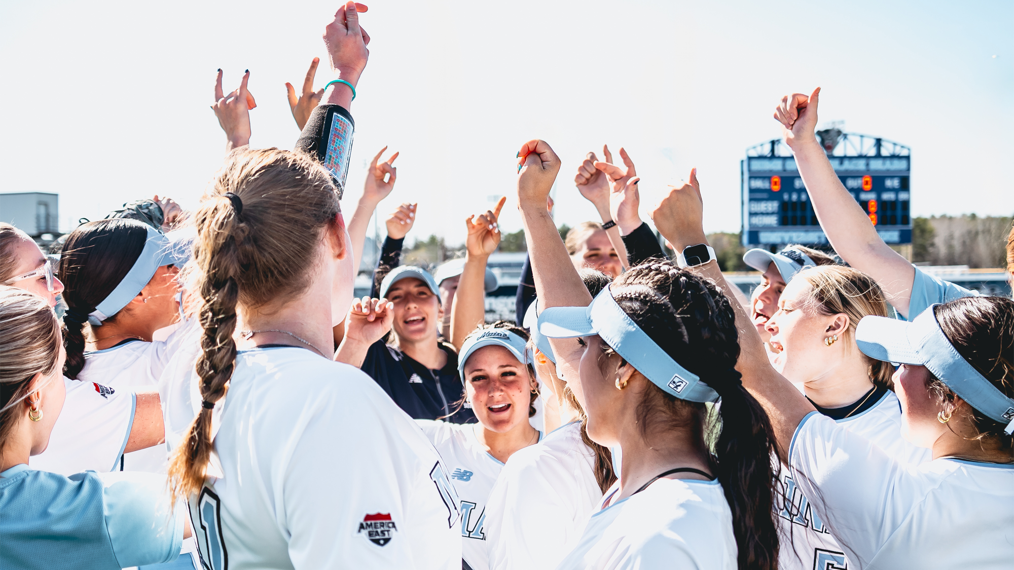 Maine softball huddles.