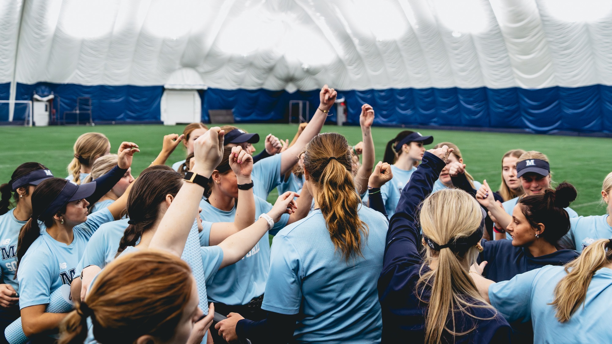 Maine softball cheers after practice.