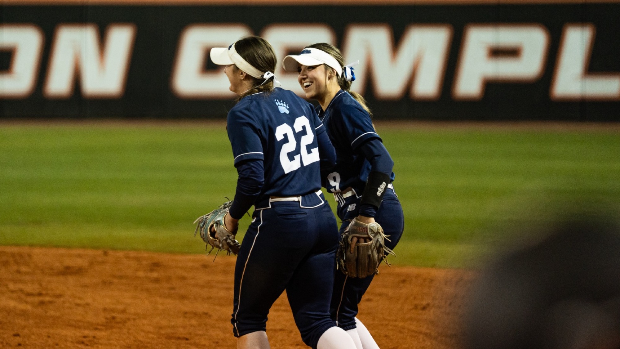 Francesca Guerrera and Madison Hand celebrate in the field.