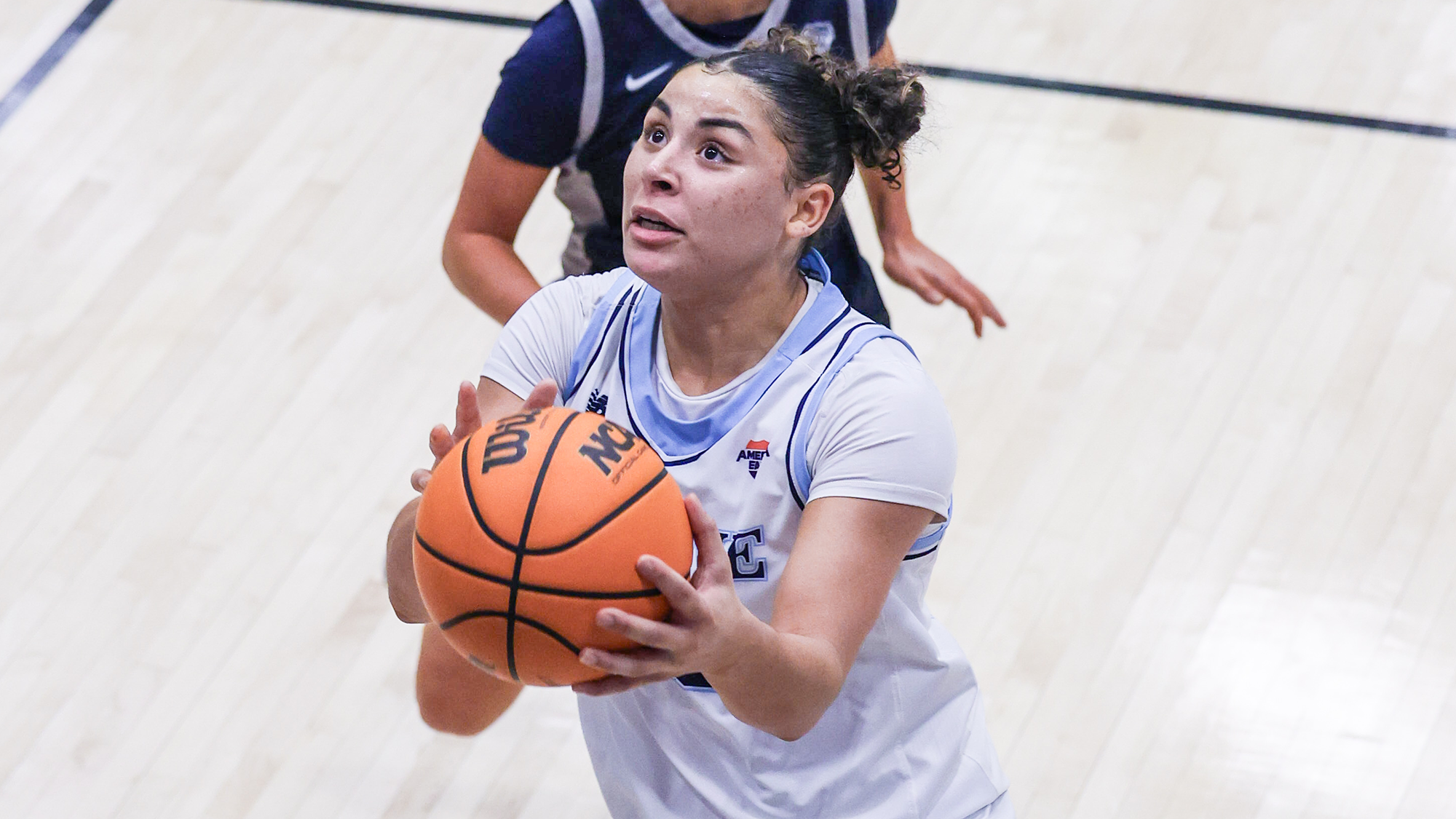 Adrianna Smith makes a layup against UNH in playoff game.