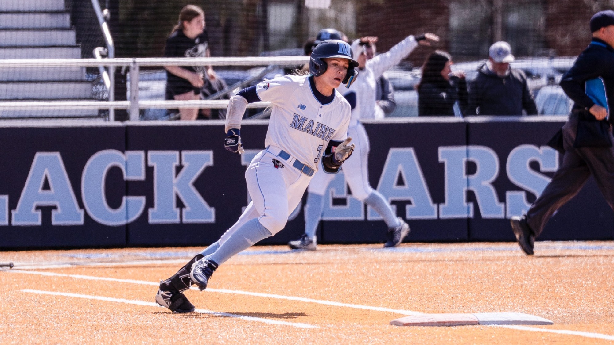Neve Adams rounds first base.
