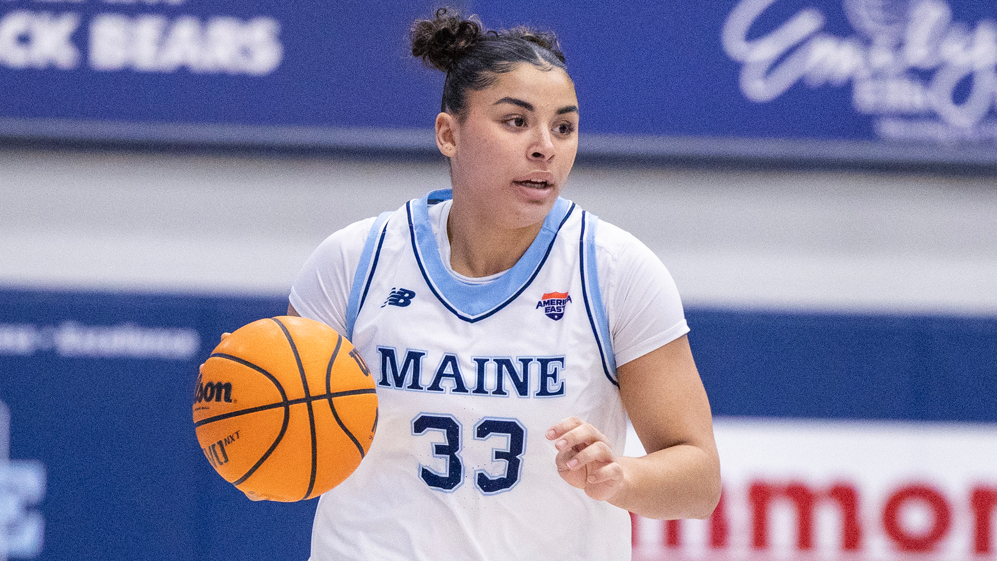 Adrianna Smith dribbles the ball against UNH