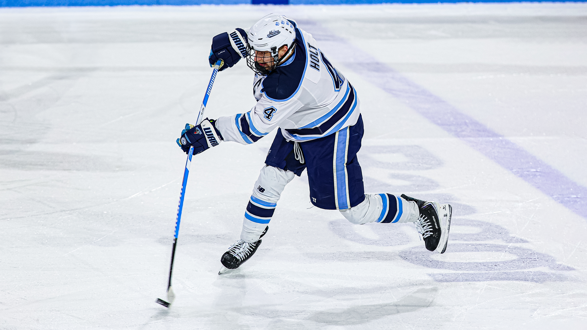 Brandon Holt shoots the puck into the offensive zone.