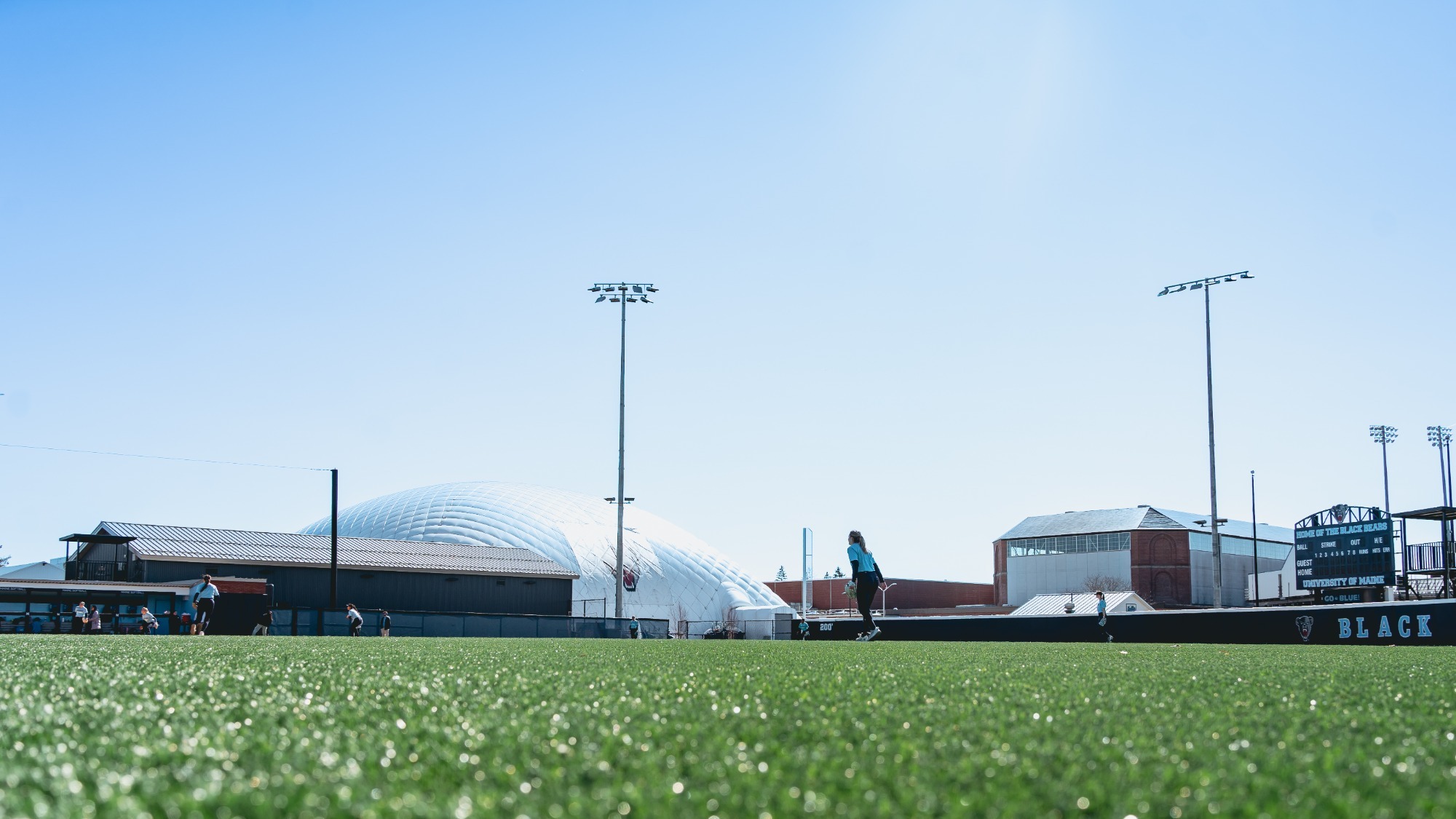 A wide shot during practice of the Maine softball field.