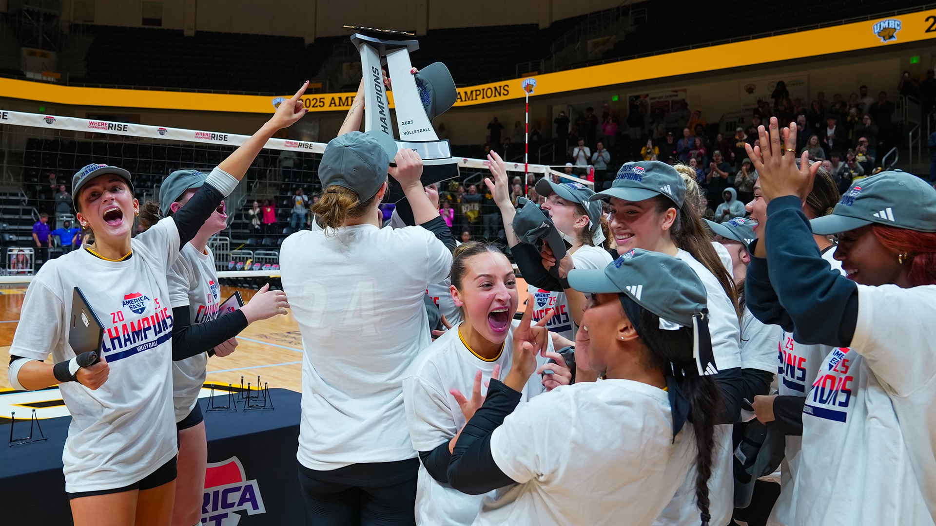 UMBC Celebrates its championship by lifting the trophy