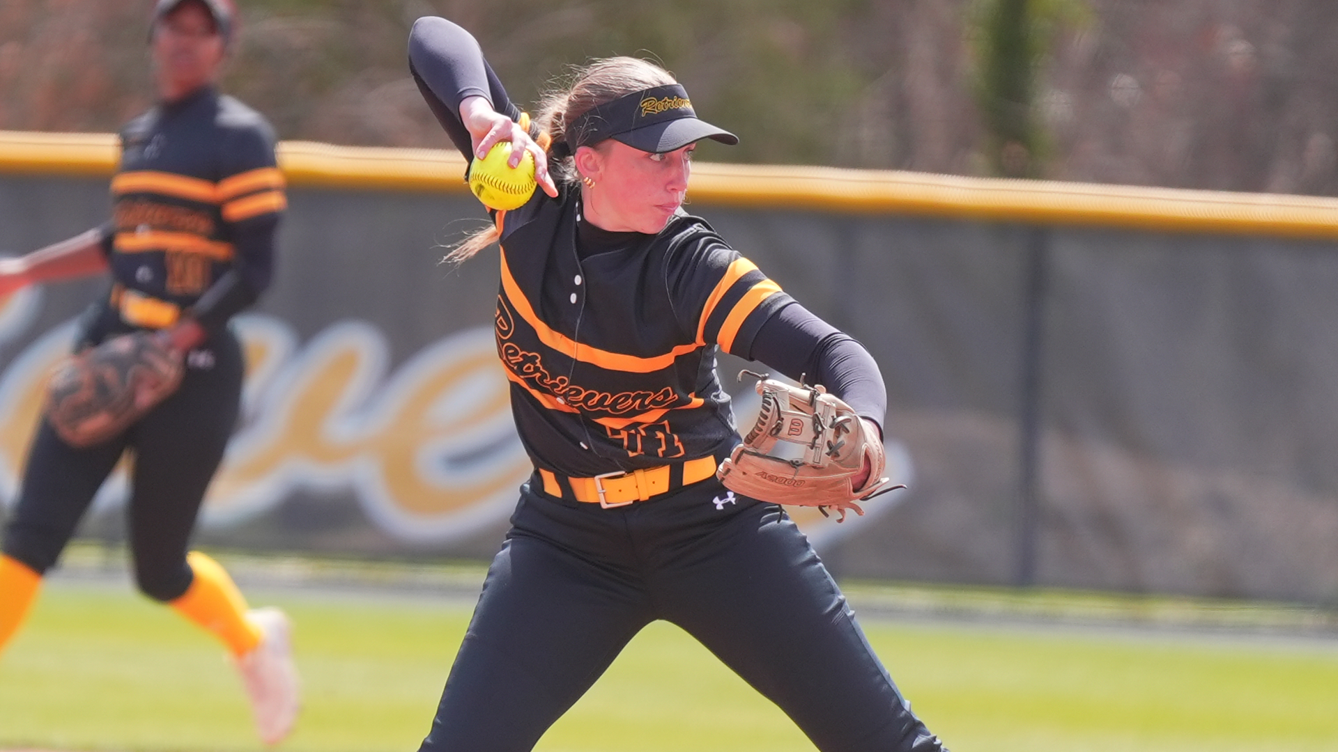 Emily Riggs throws out a runner against UMass Lowell