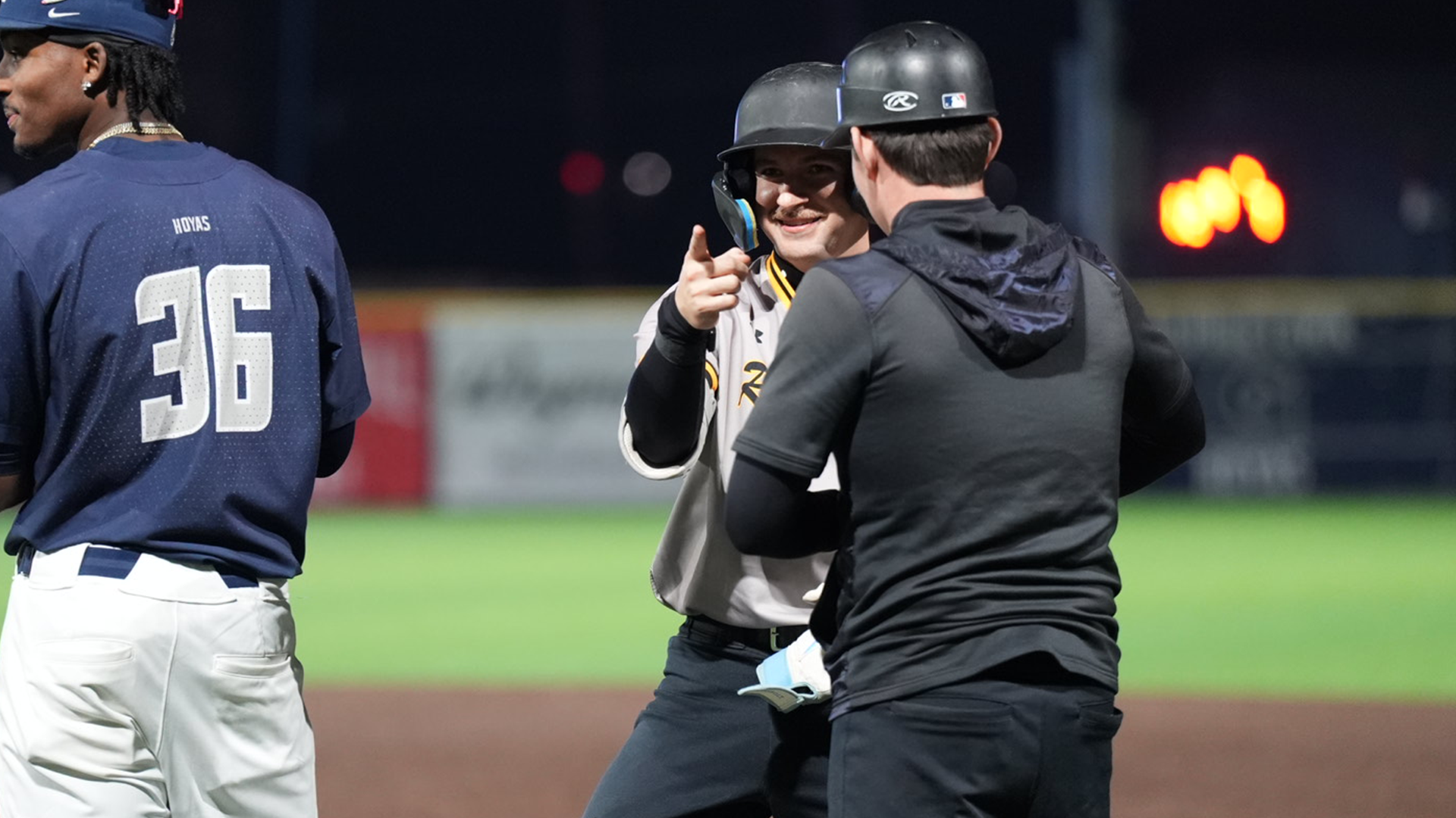 Dylan Melton celebrates at first base after a hit