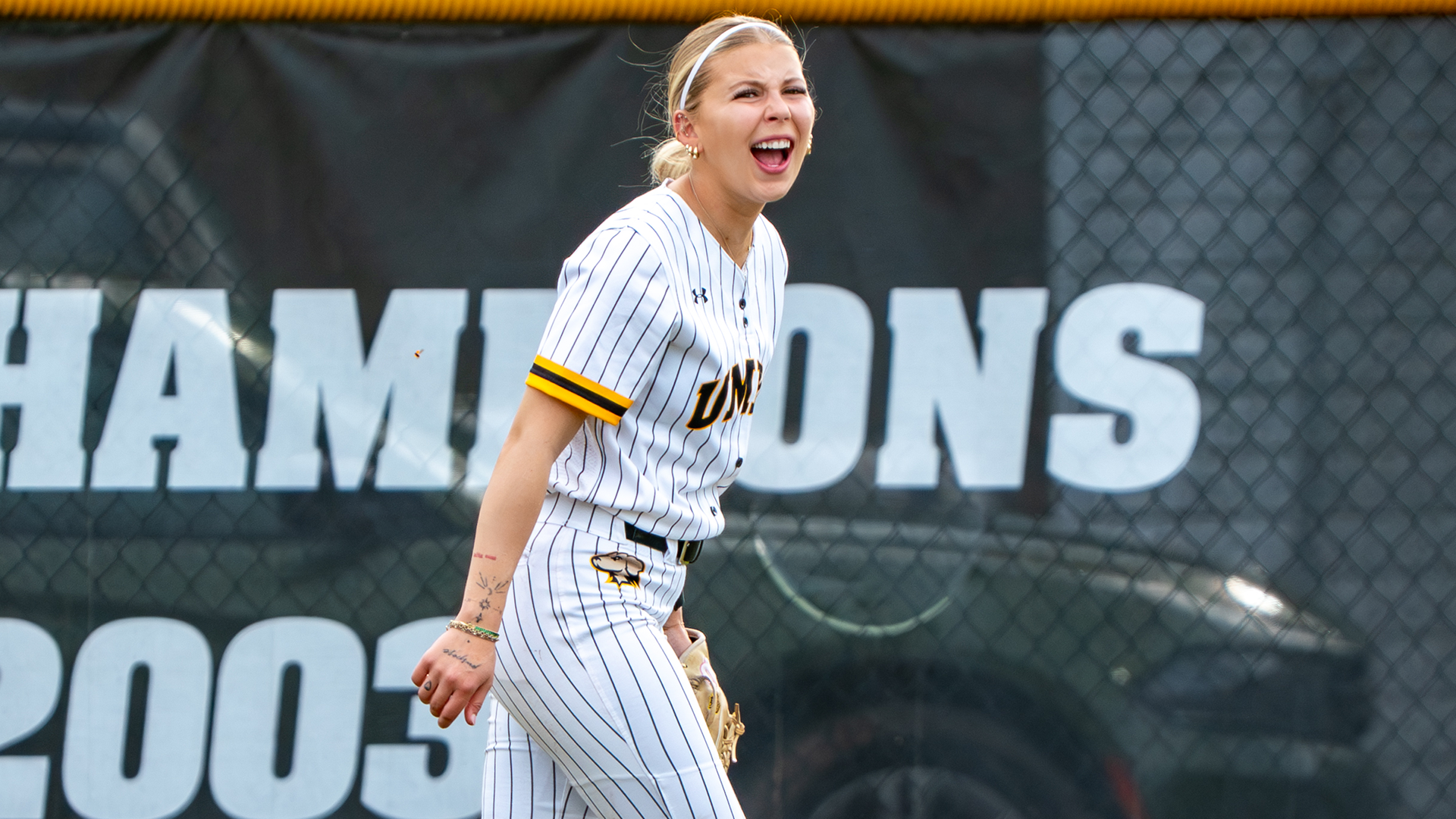 Catelyn Thrush cheers from the outfield against Morgan State