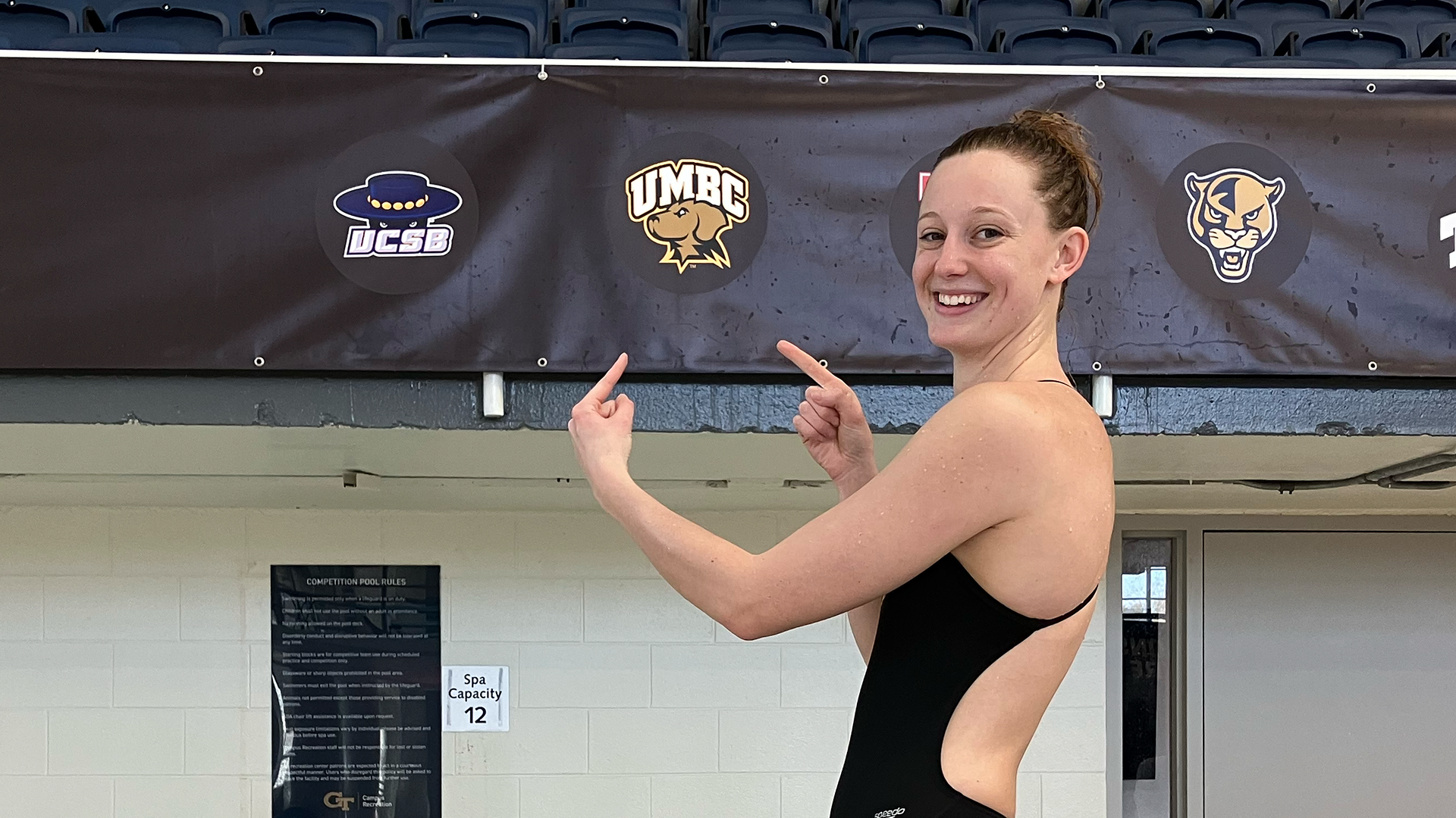 Ashley Gutshall points to the UMBC logo at NCAA Championships in Atlanta