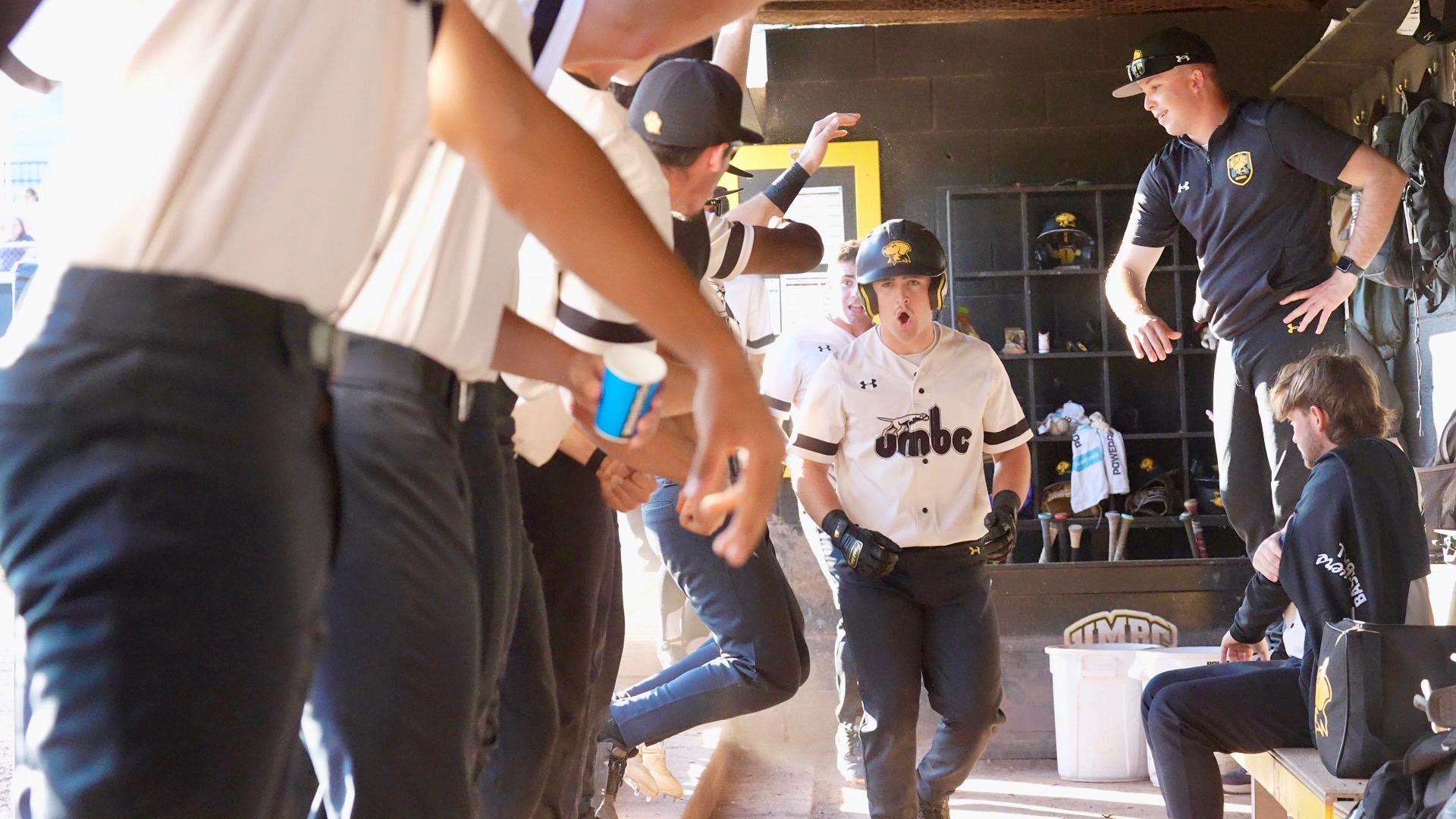 Brooks Henderson gets high-fives in the dugout after hitting a grand slam against UMass Lowell