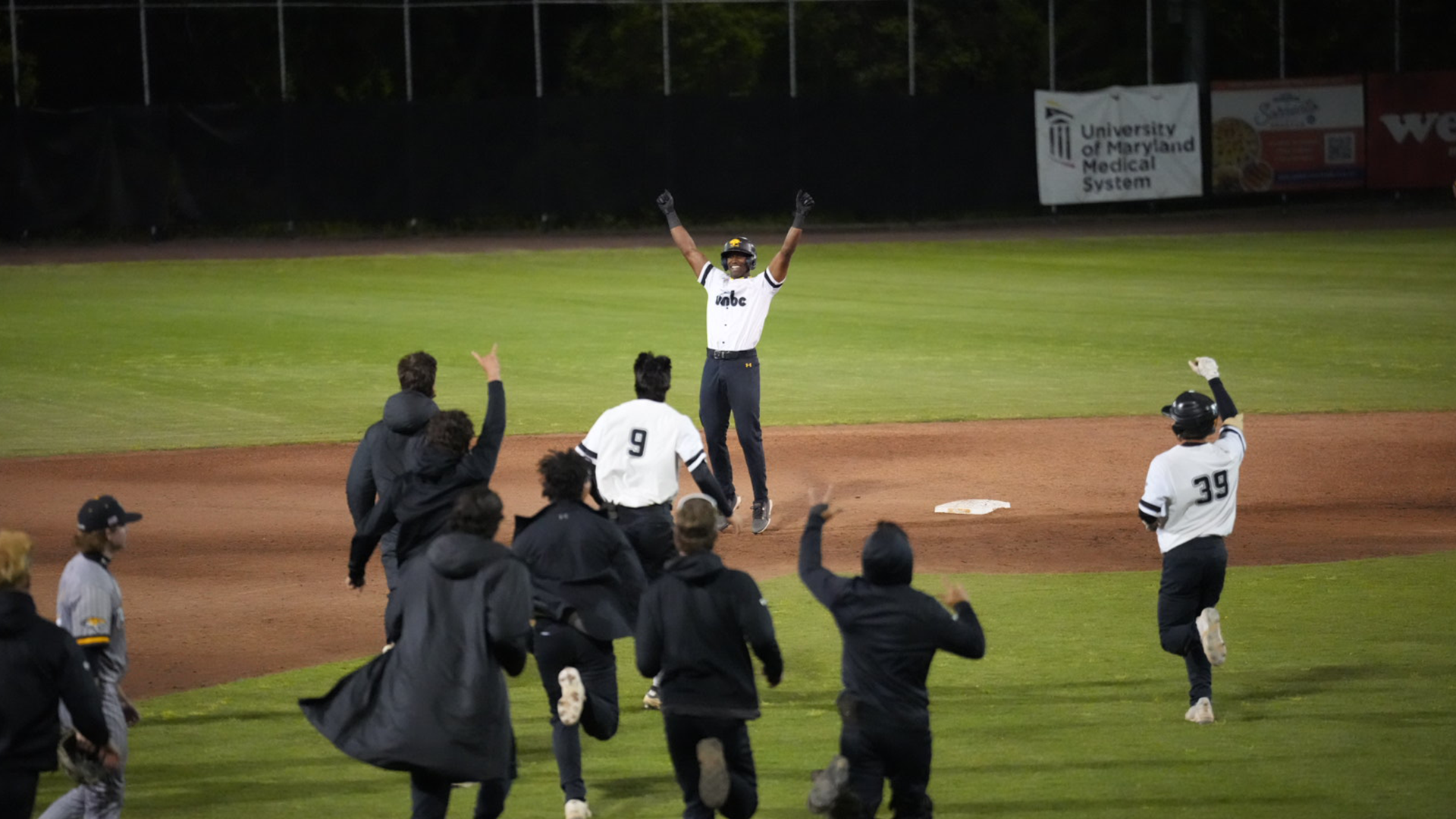 Ehi Okojie celebrates hitting a walk-off single against Towson and is mobbed by his teammates at second base