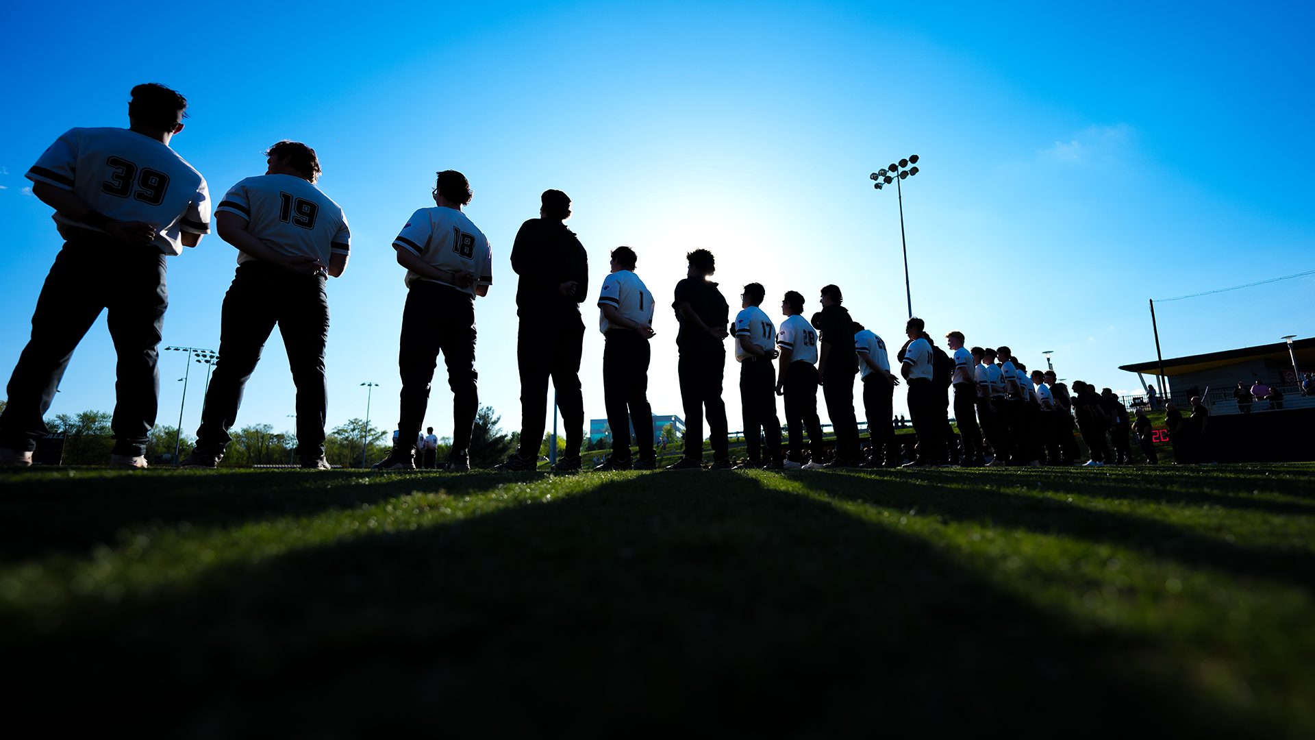 UMBC Baseball stands for the anthem prior to its game against UMass Lowell