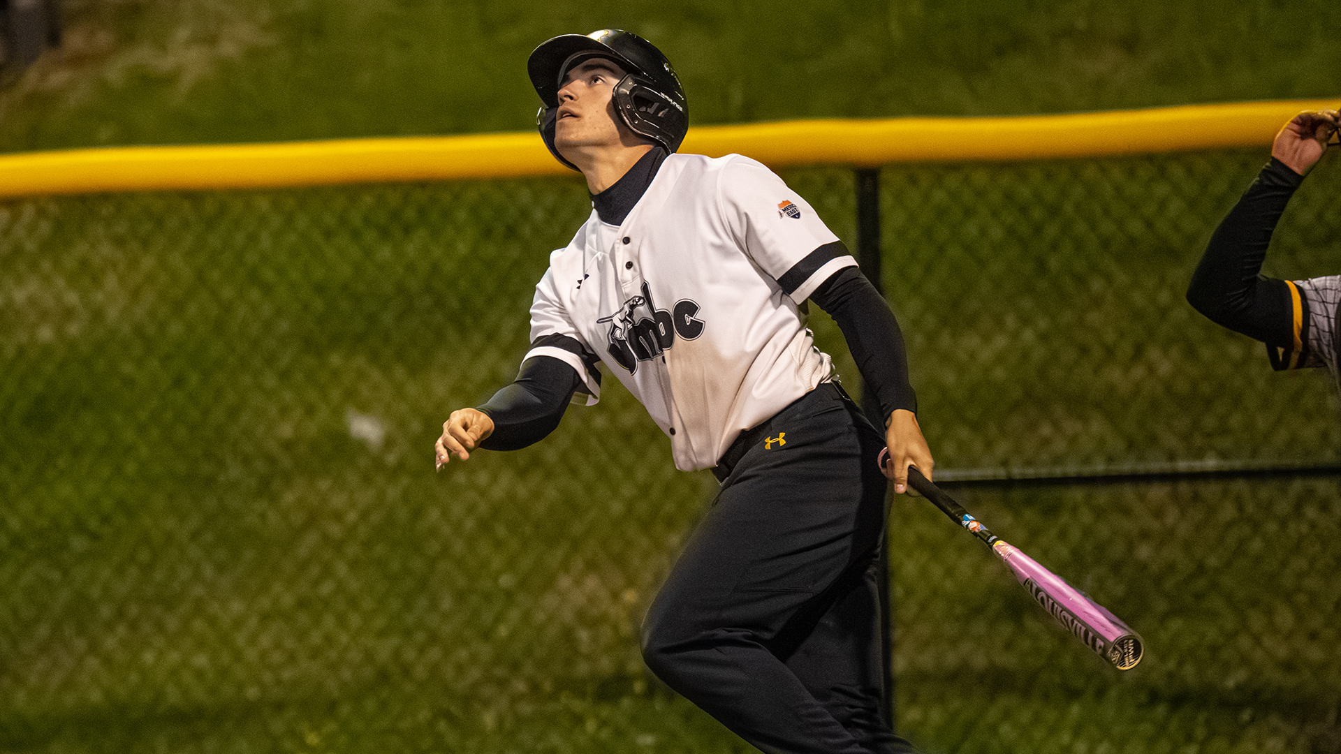 Danny Orr watches a fly ball that he just hit against Towson