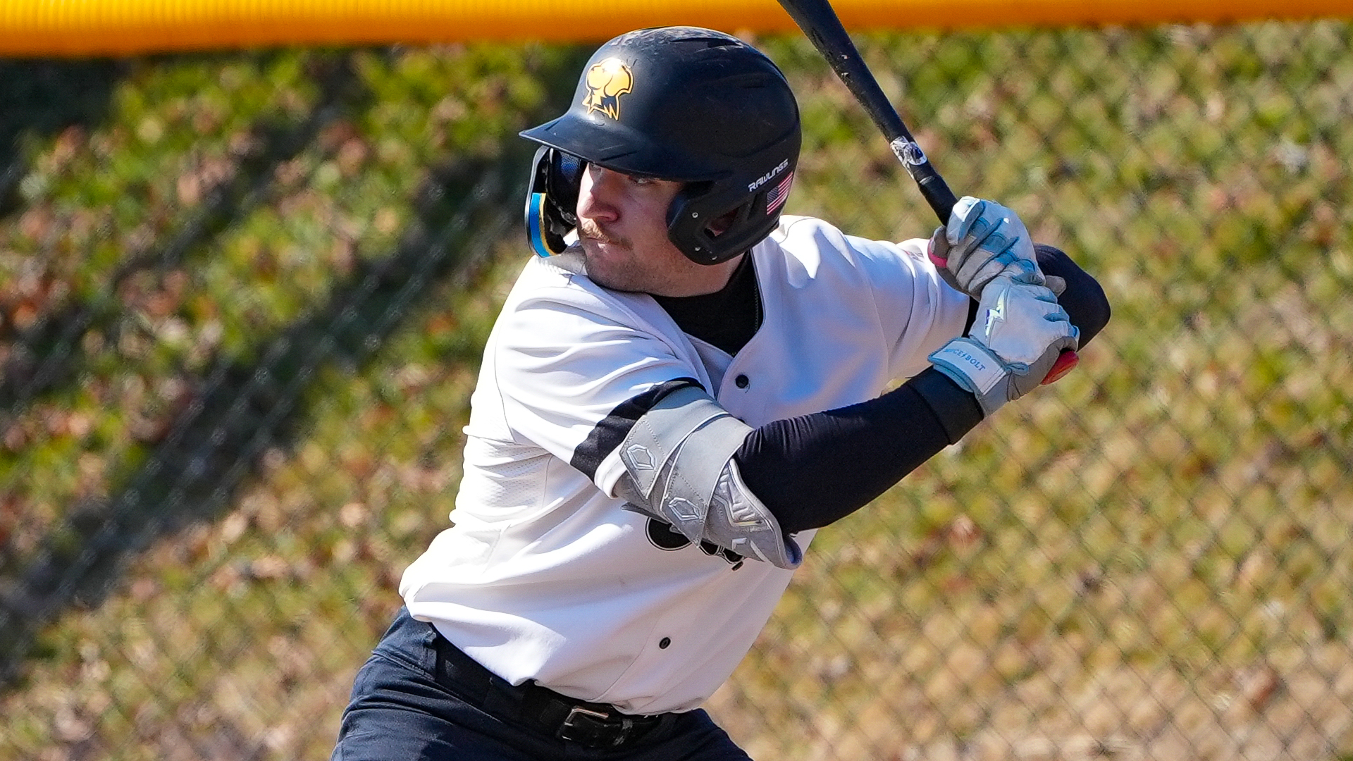 Dylan Melton bats in a white jersey with black pants