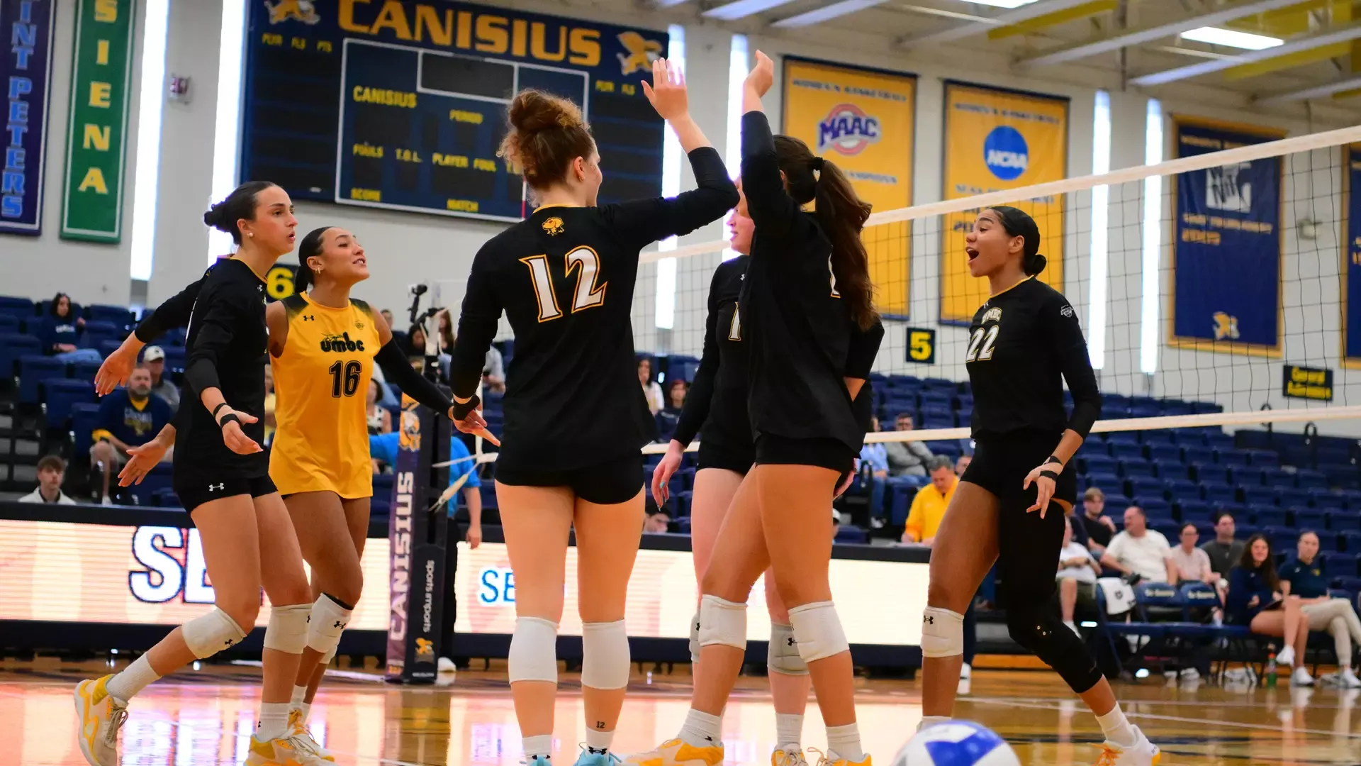 UMBC celebrates winning a set at Canisius