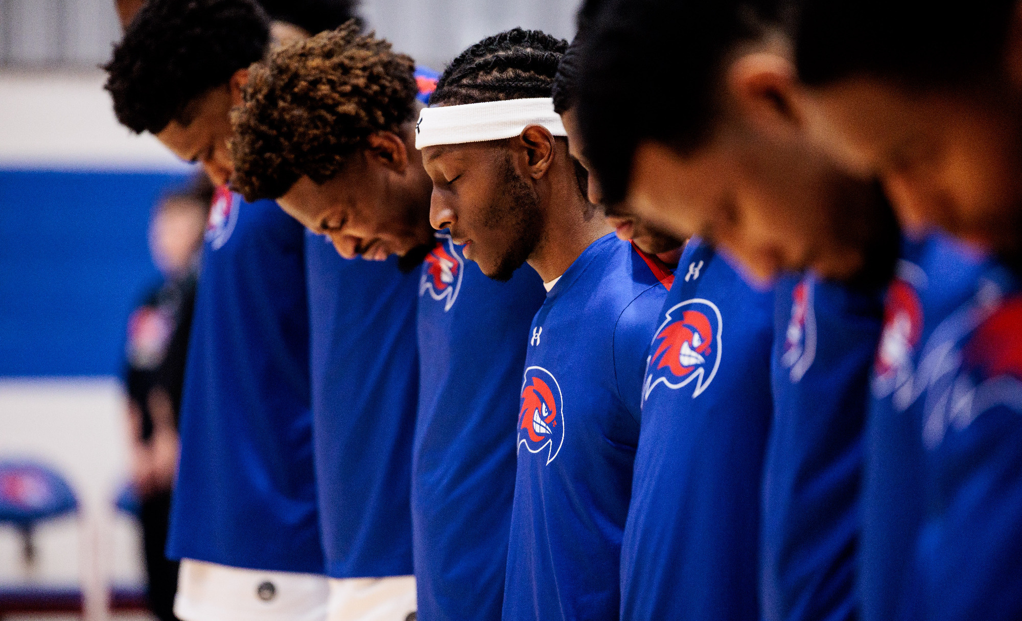 Men's Basketball players lined up for the national anthem.