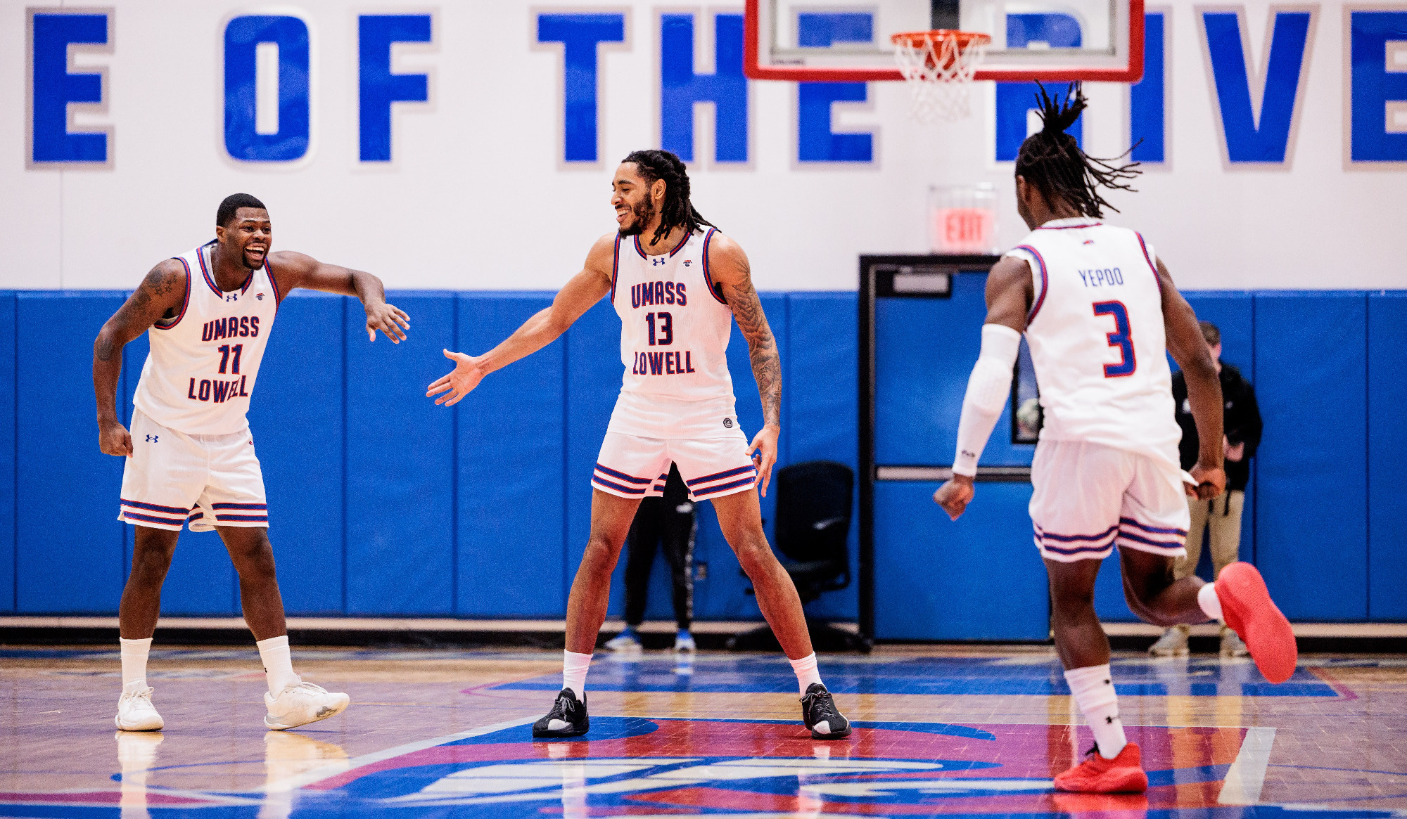 Men's Basketball players celebrating 