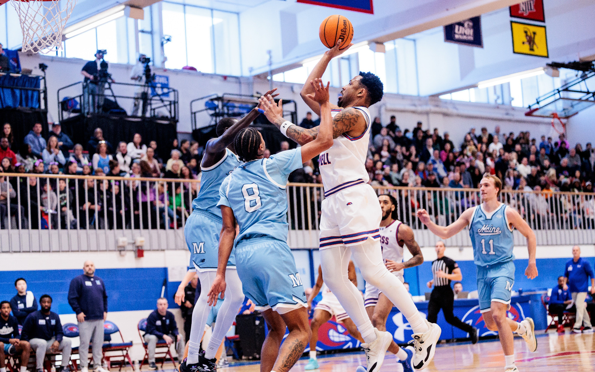 Montas Jr. shooting a one-handed jumper over Maine defenders