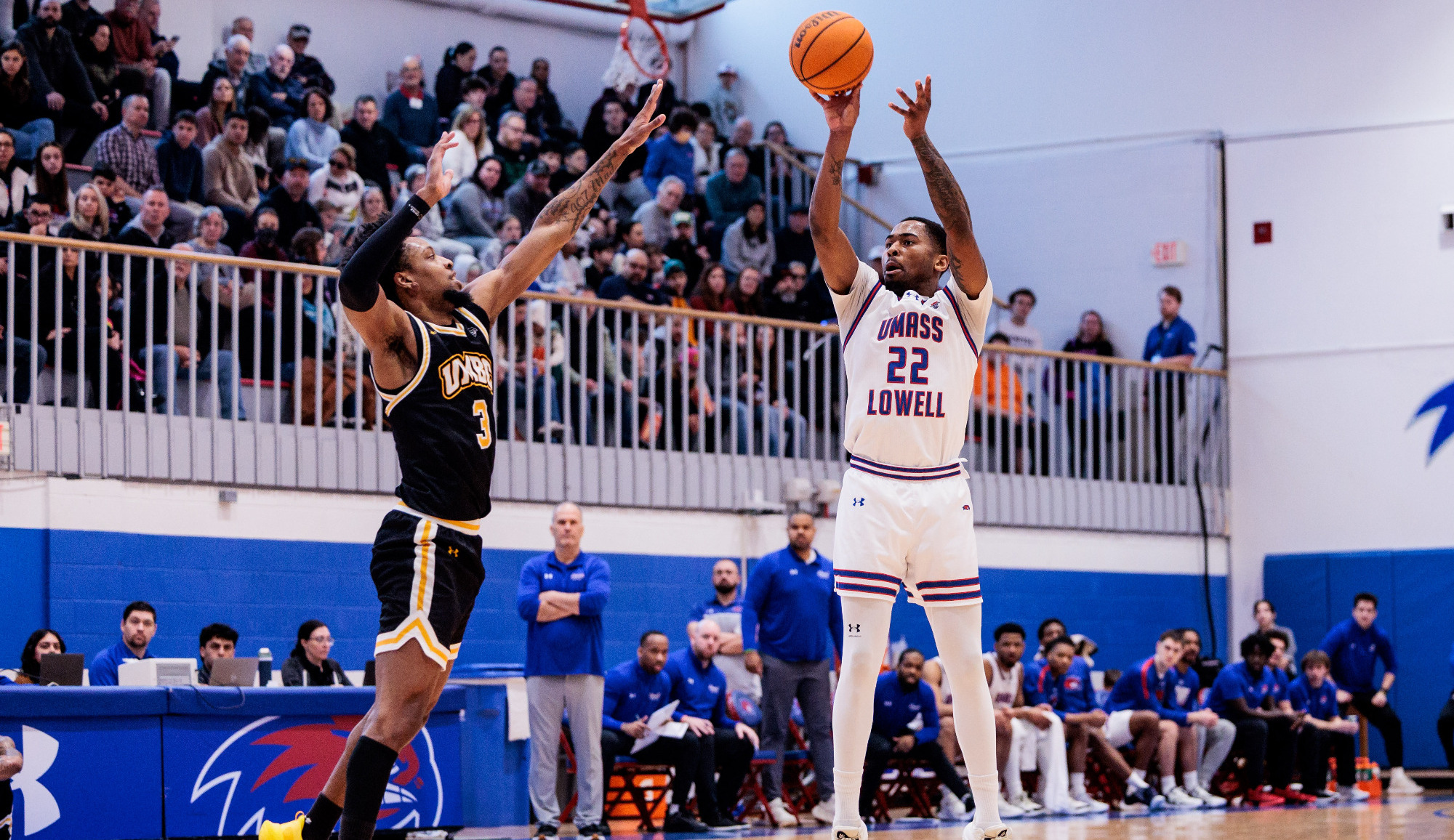 Khalil Farmer shooting a three-pointer over a UMBC defender