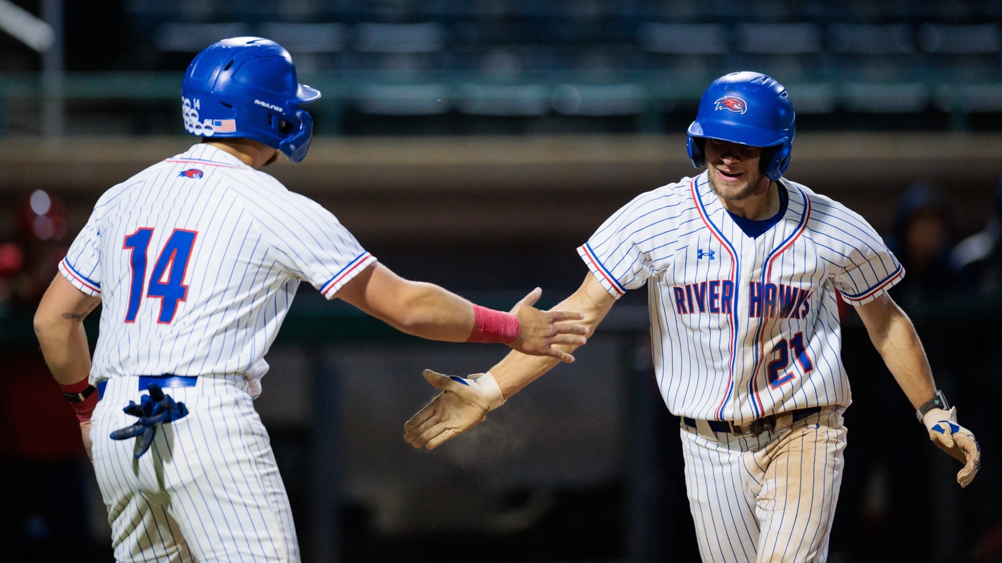 UMass Lowell baseball players celebrating after scoring a run during its match against NJIT on April 10, 2026