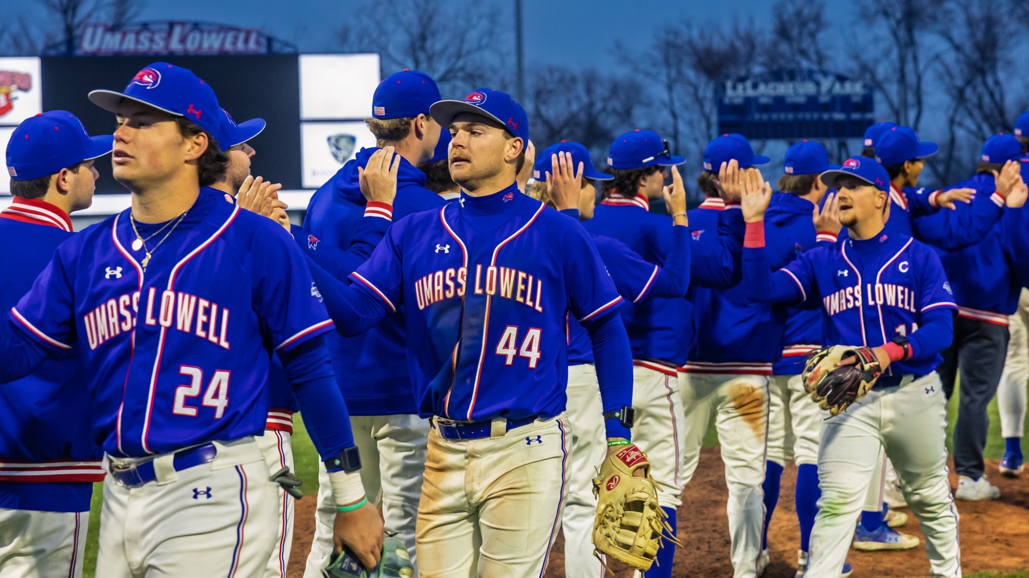UMass Lowell baseball players high fiving and celebrating post game after a win over Dartmouth on March 31, 2026