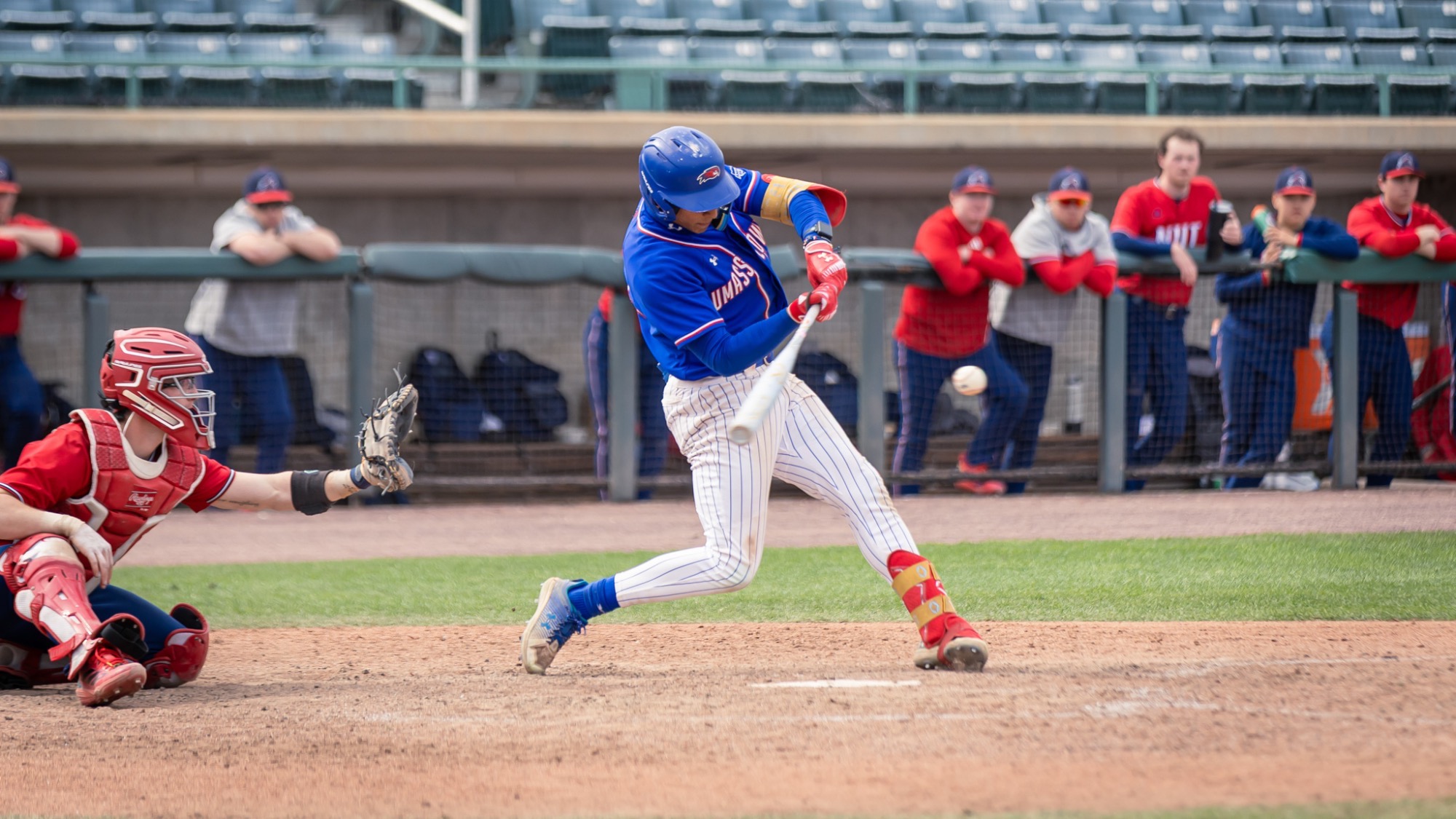 UMass Lowell baseball player at the plate swinging at a pitch throw down the middle 
