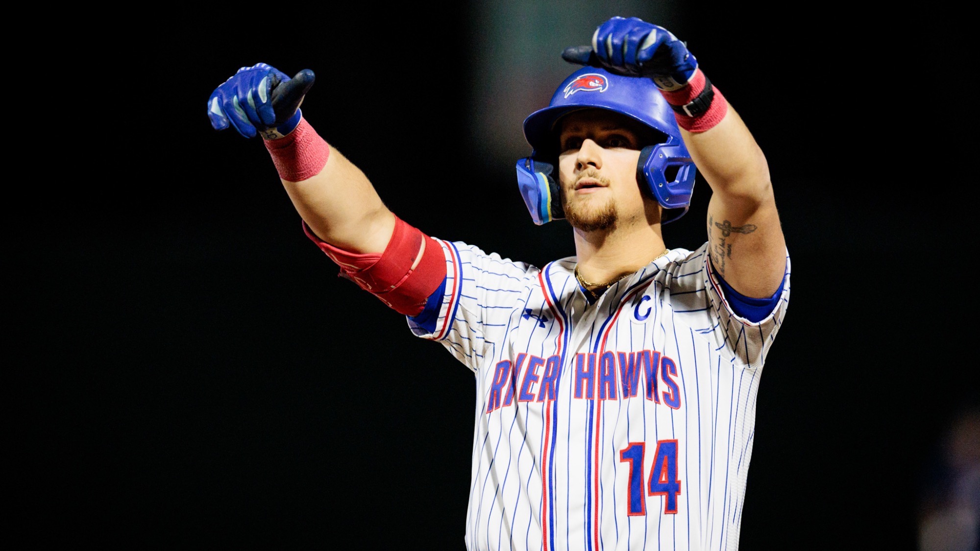 UMass Lowell baseball player doing a celebration after getting on base from a hit
