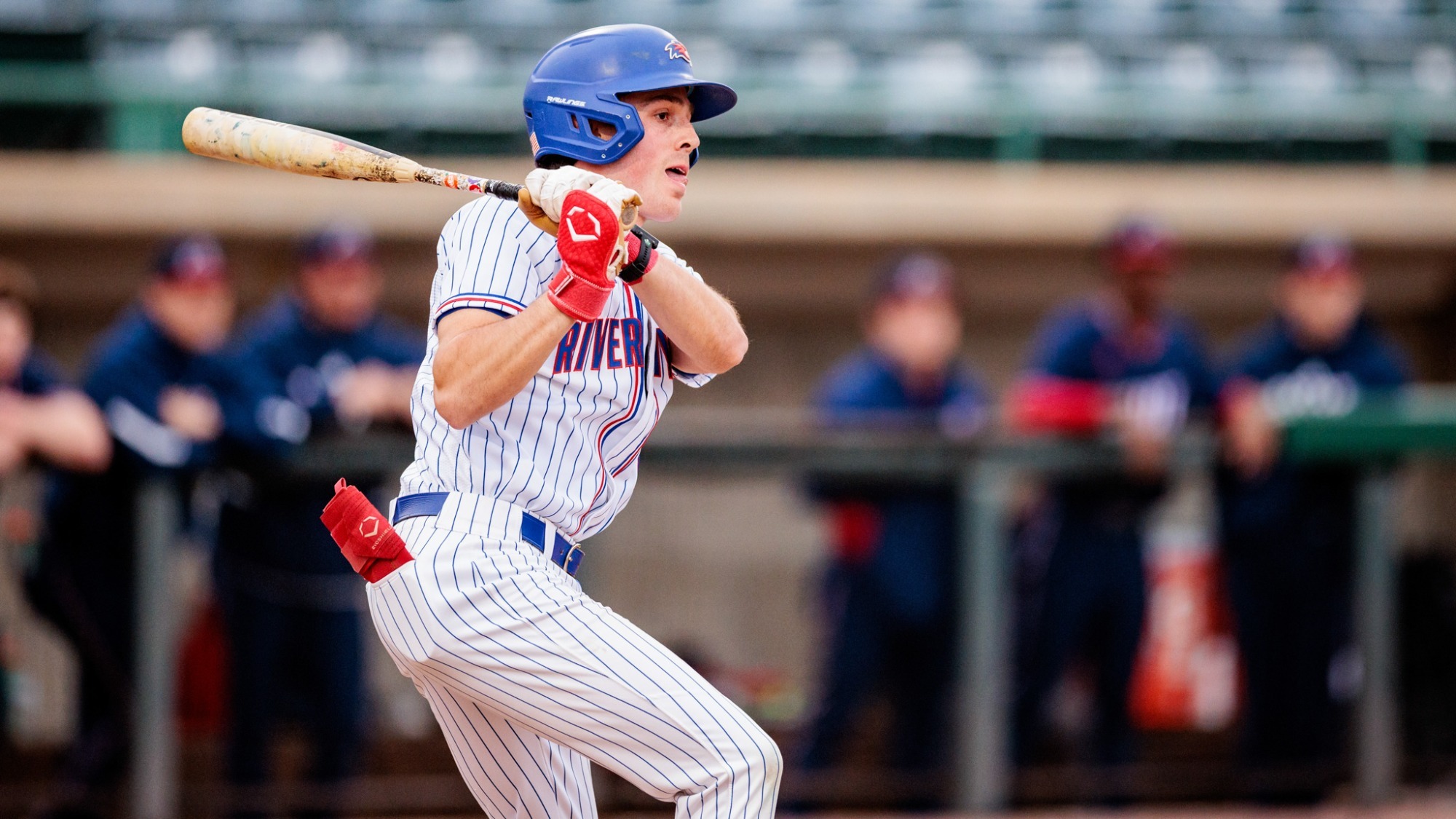 UMass Lowell baseball player hitting the ball into play during his plate appearance at Edward A. LeLacheur Park