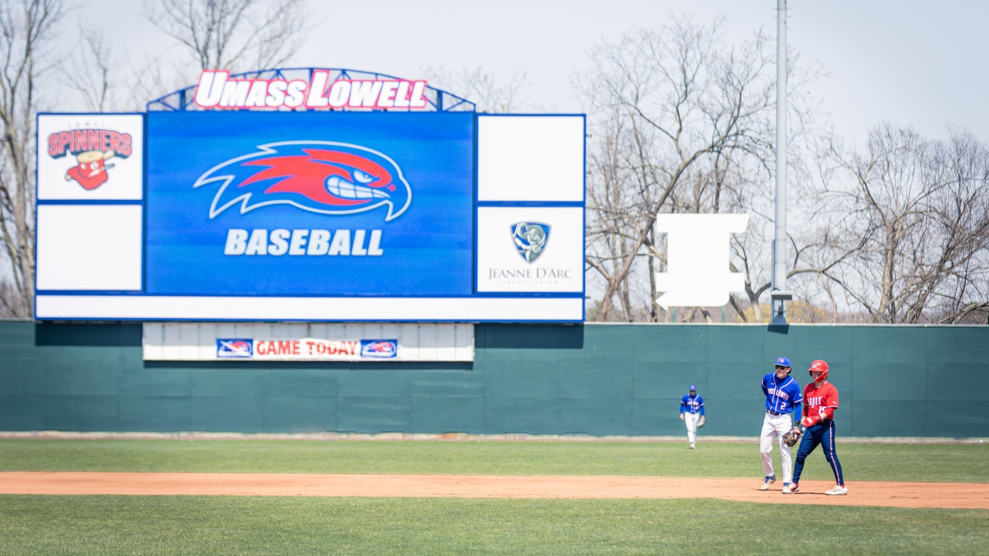 Edward A. LeLacheur Park with a videoboard in the back of the field, and baseball players on the ballpark playing baseball