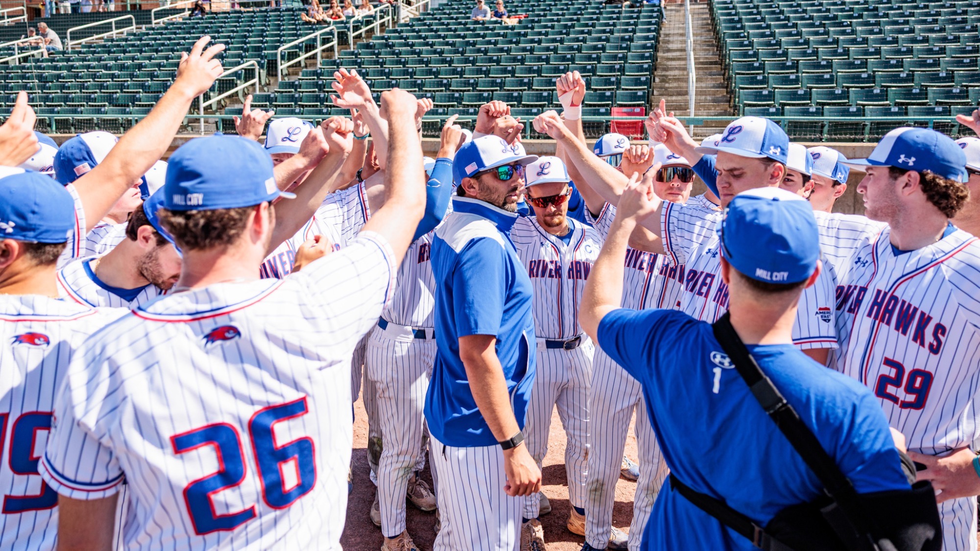 UMass Lowell baseball team huddled up for a pre game speech, and then breaking the huddle down before the game begins