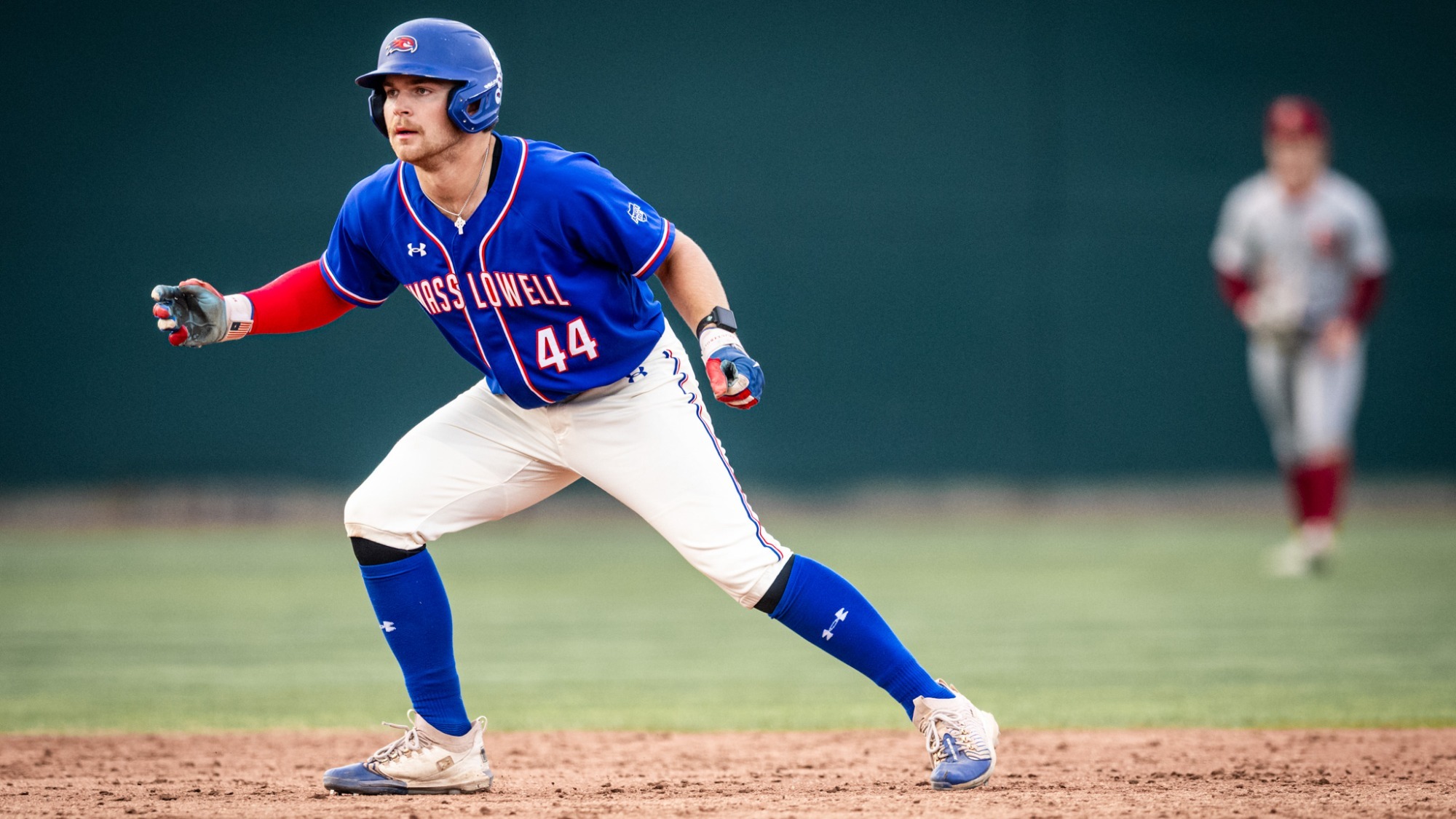 UMass Lowell baseball player drifting his way off the base, and is getting ready to steal, or run due to a hit