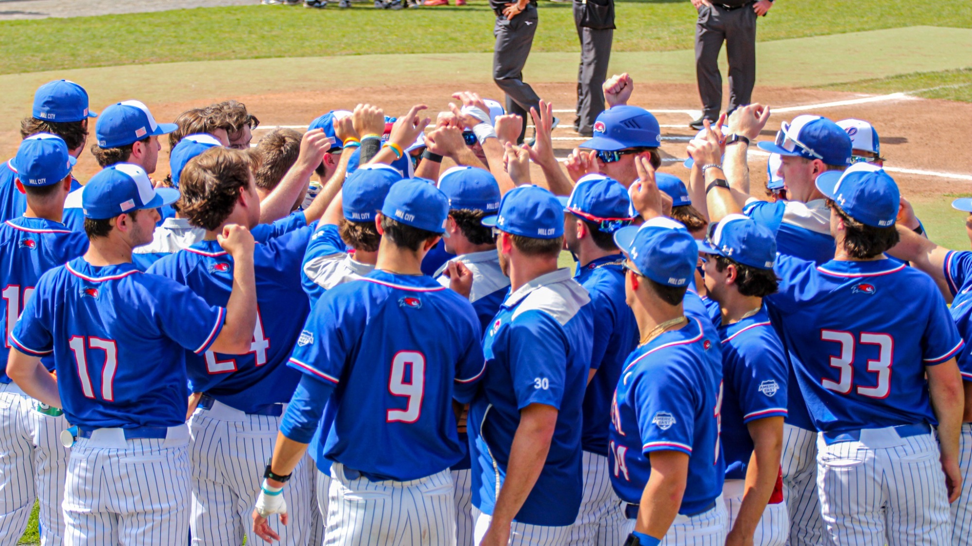 UMass Lowell baseball team huddled up before the game getting ready to break it down and play some ball