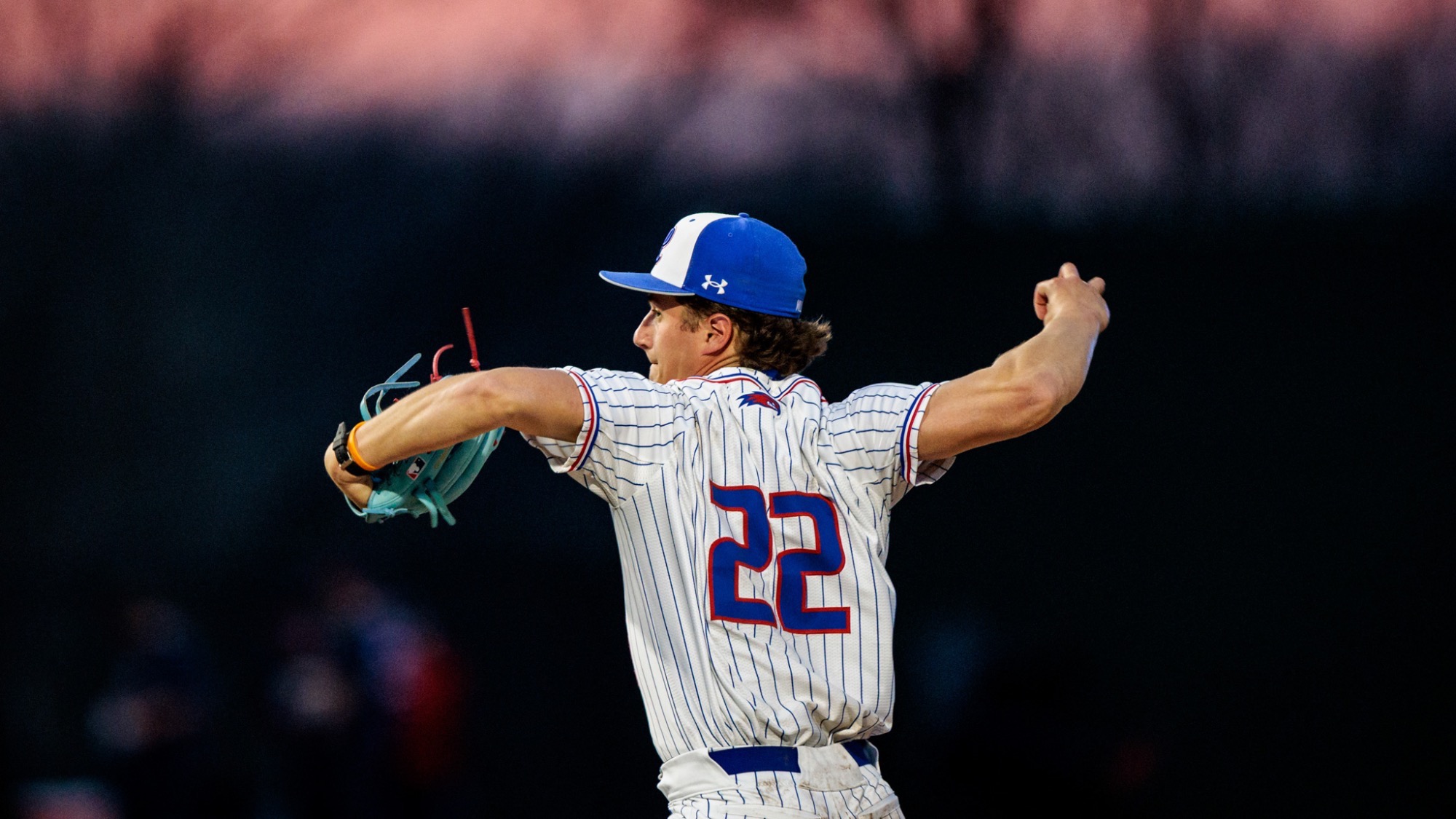 UMass Lowell baseball pitcher getting ready to throw the ball on the mound down the strike zone to an opposing batter 