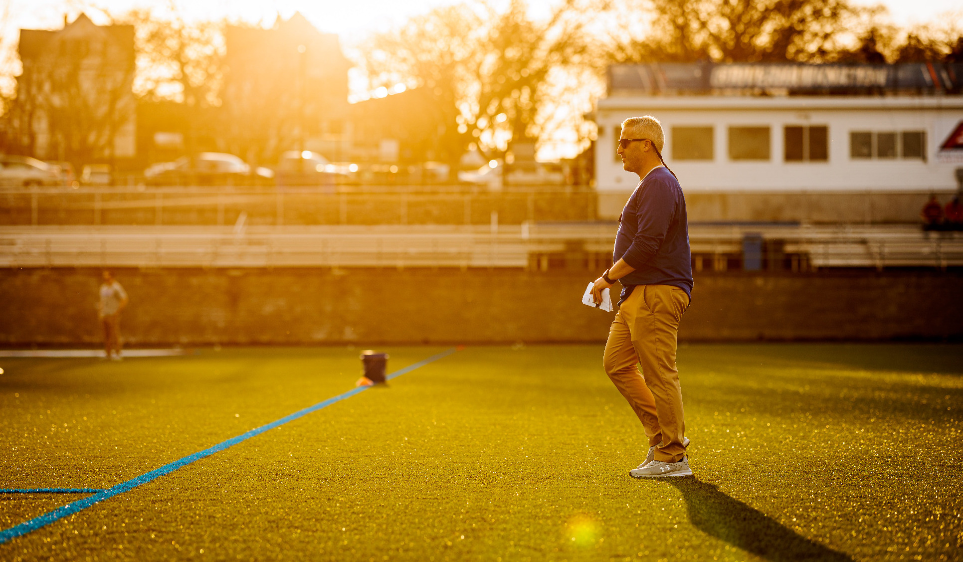 Drew Kelleher walking on field at sunset