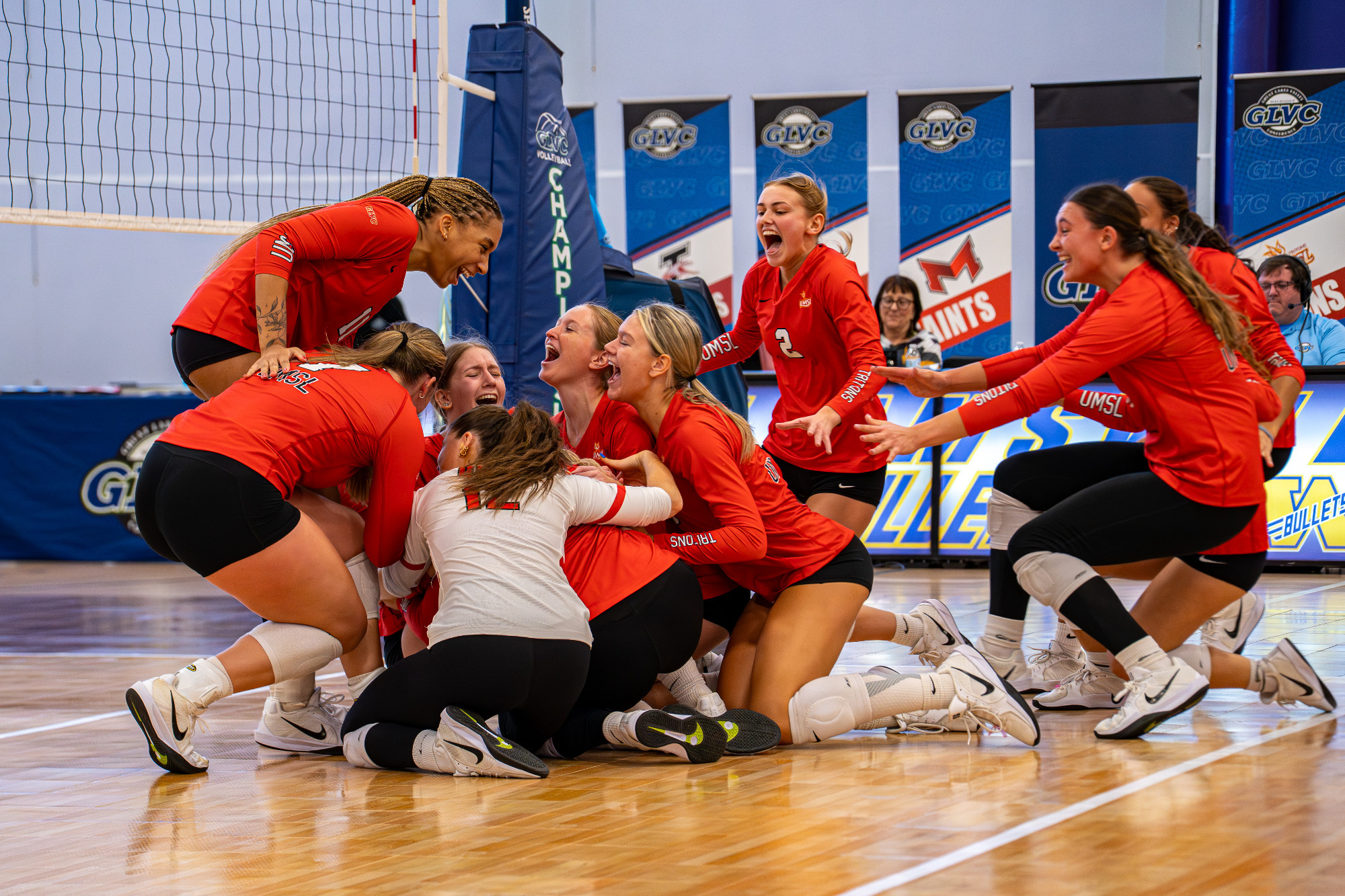 UMSL Volleyball dogpile celebration after winning the Great Lakes Valley Conference title