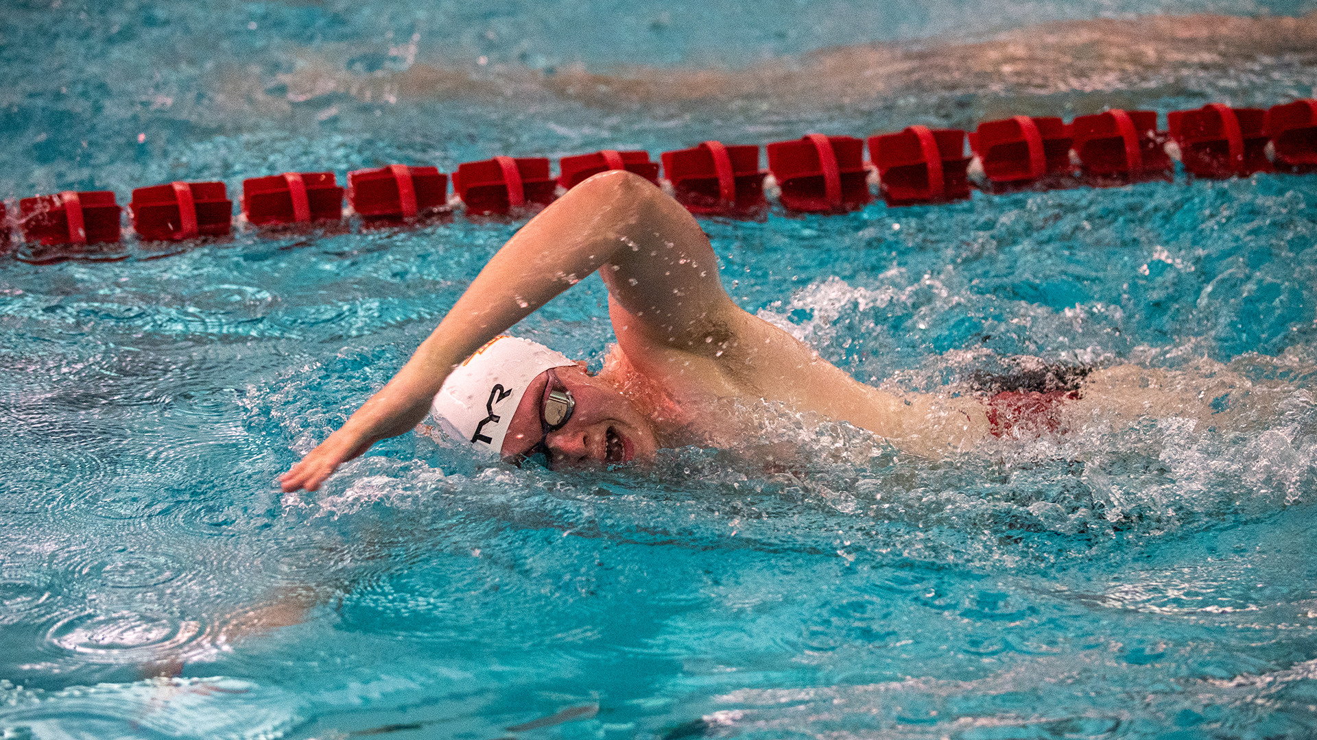 UMSL men's swimmer swimming a freestyle event