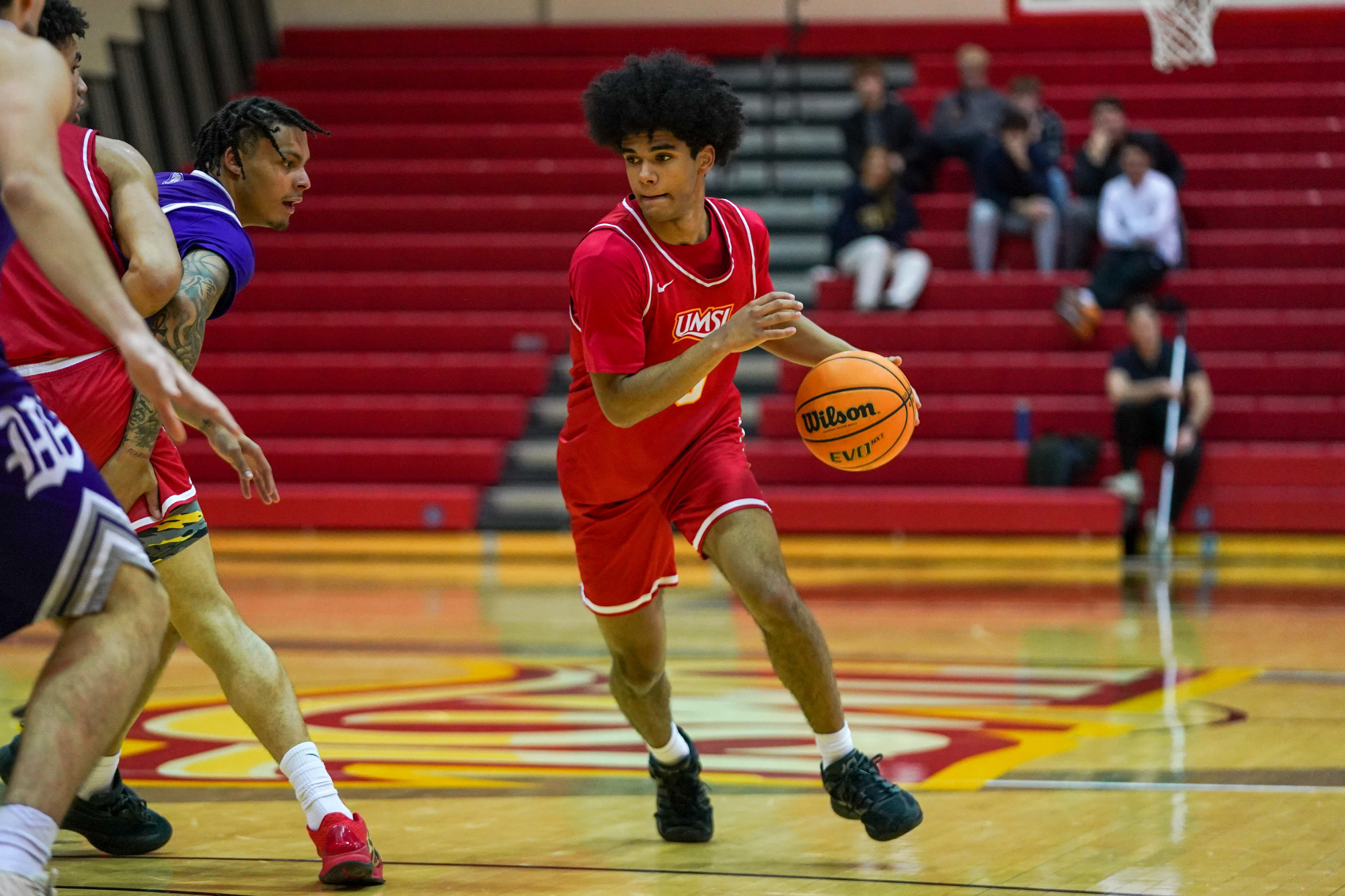 Taye Moore dribbles the basketball
